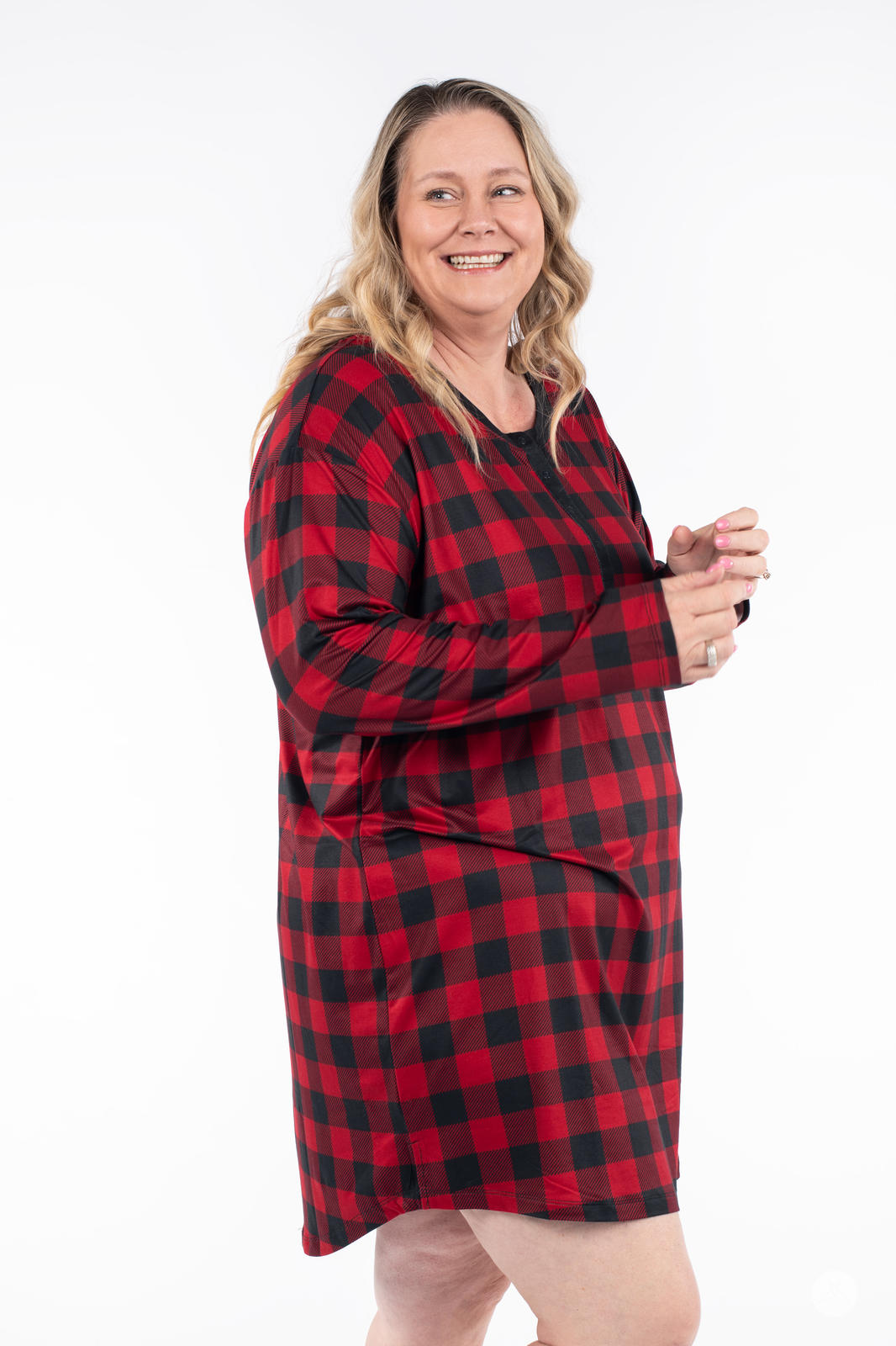 Plus size model wearing SweetTops Henley Sleep Shirt in red buffalo plaid with long sleeves and relaxed fit side view