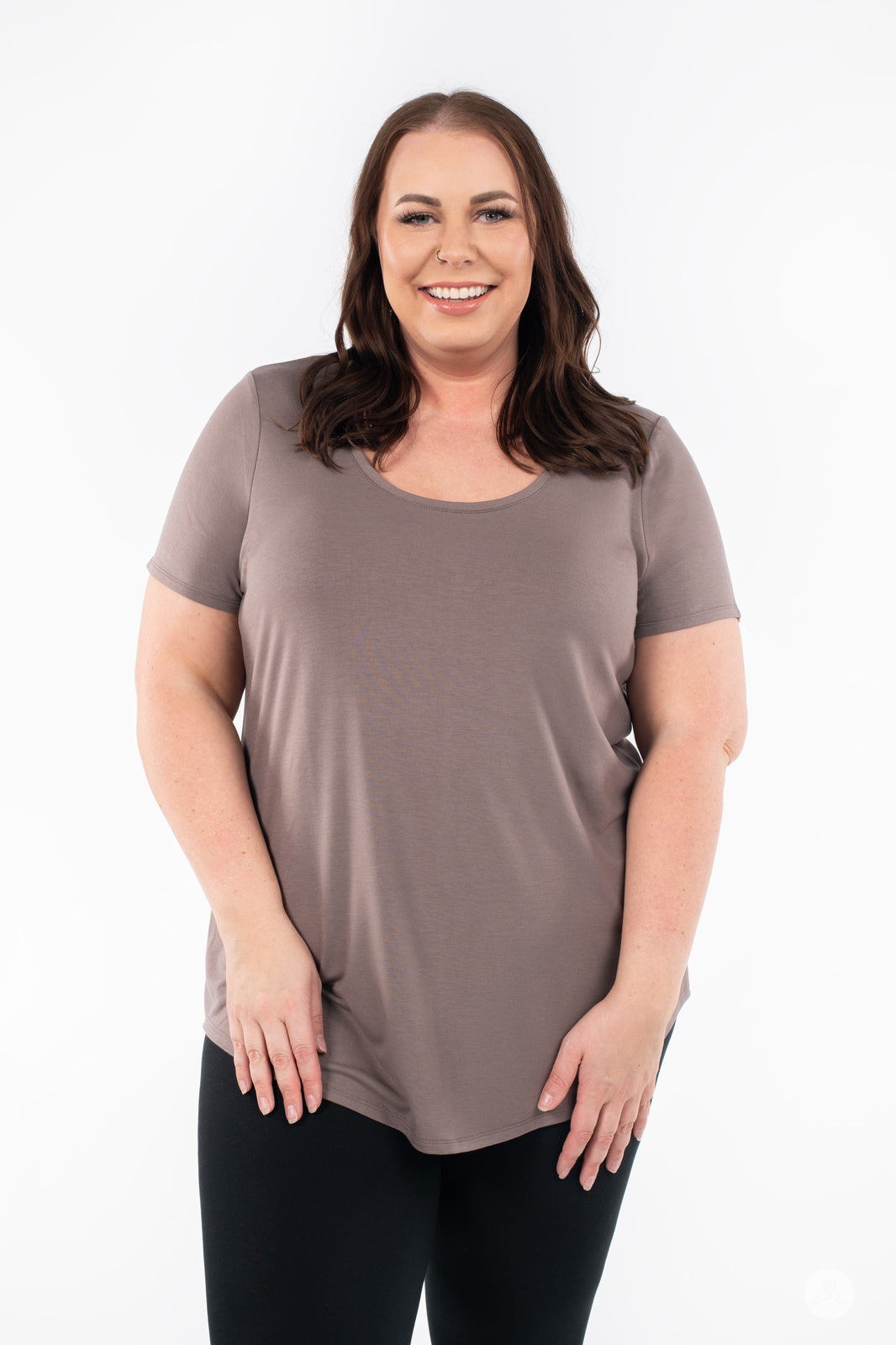 Plus-size woman smiling wearing SweetLegs Canada Scoop Neck Tee in muted taupe with curved hem front view
