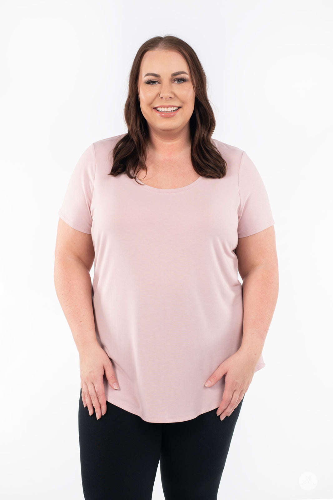Plus-size woman smiling wearing SweetLegs Canada Scoop Neck Tee in soft pink with curved hem front view
