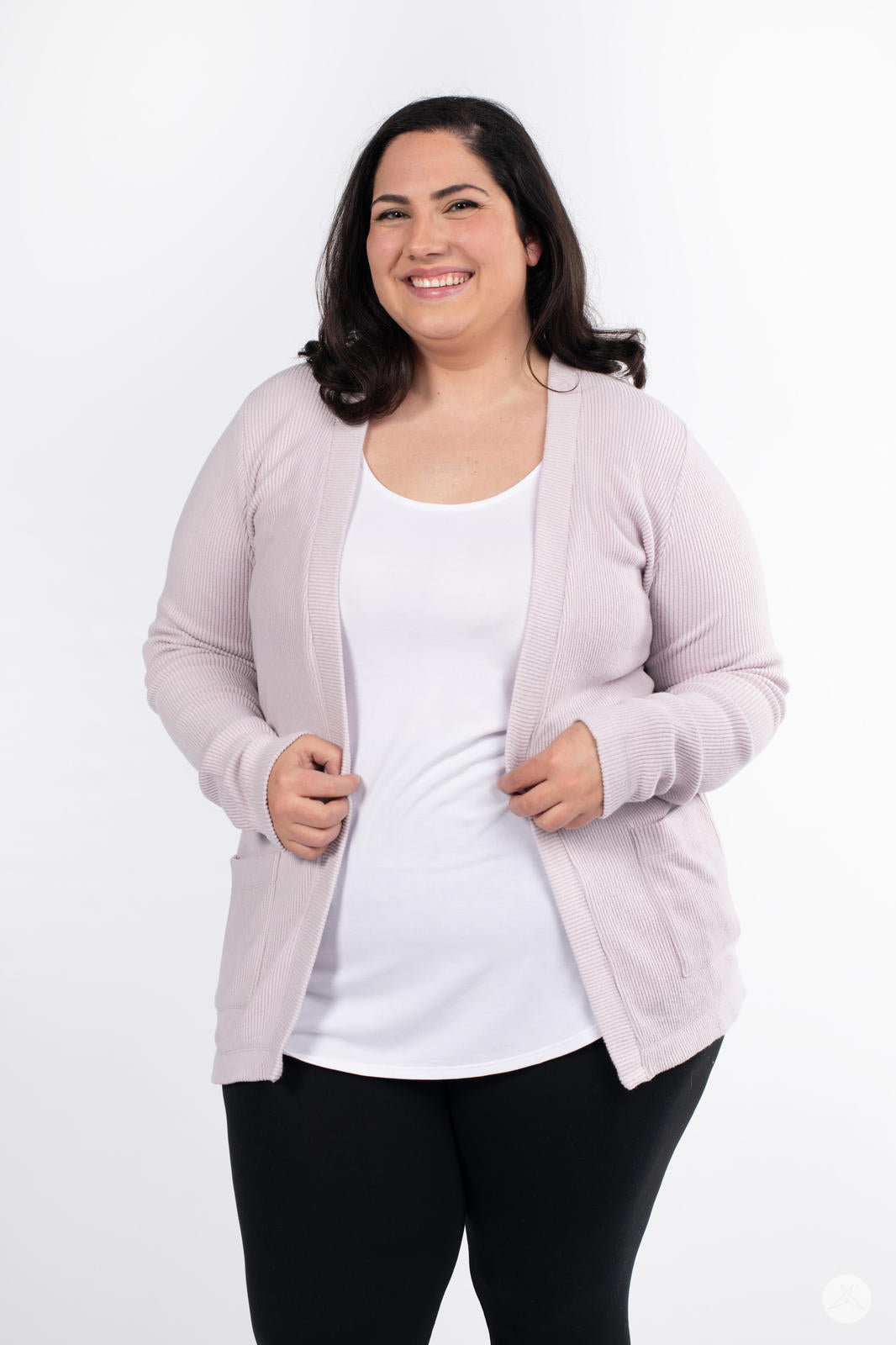 Plus-size model smiling wearing SweetLegs Canada Ribbed Comfort Cardigan in soft light pink with front pockets and open style