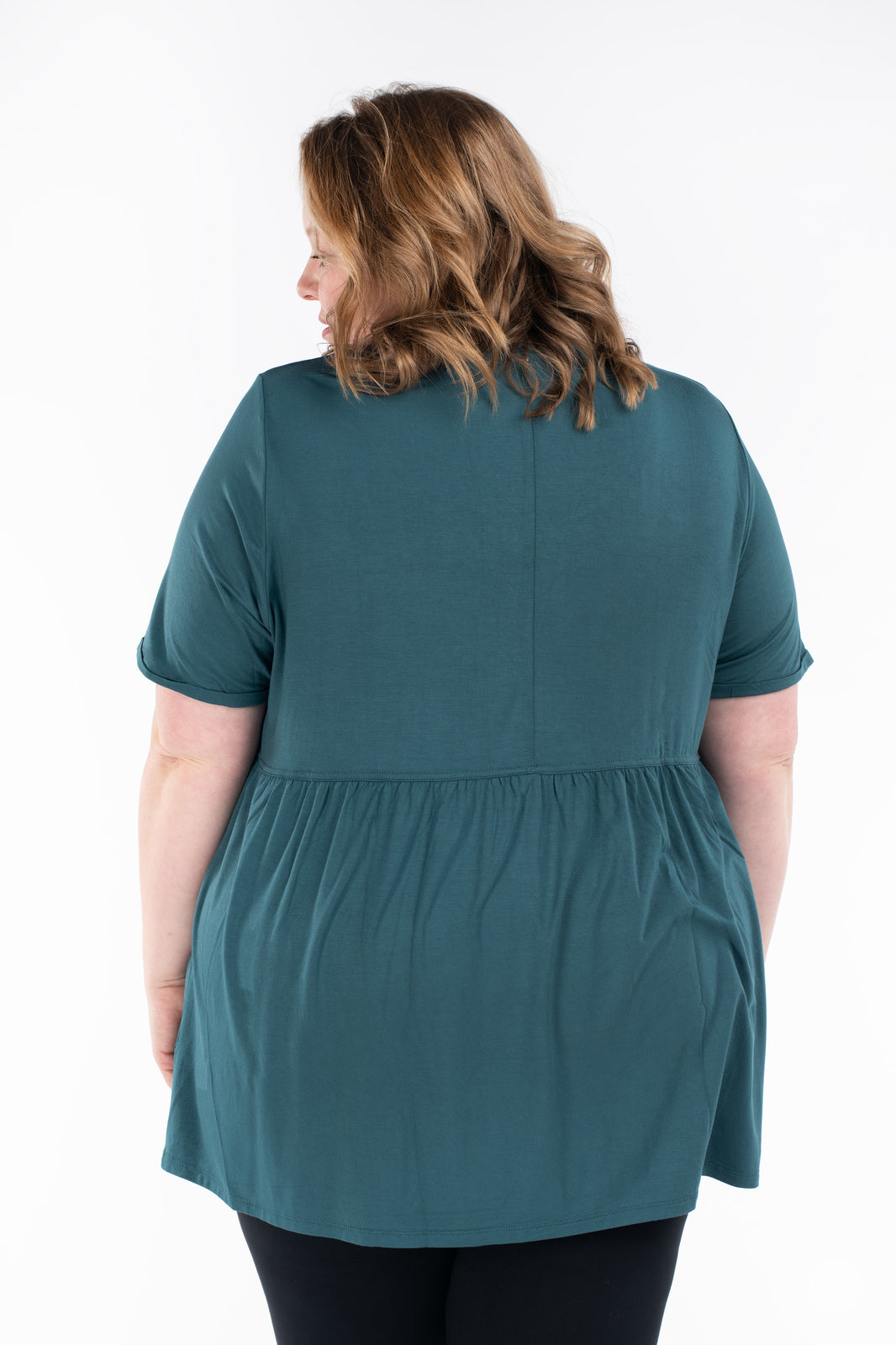 Plus-size woman shown from behind wearing teal Babydoll Tee by SweetLegs Canada with gathered waist and short sleeves