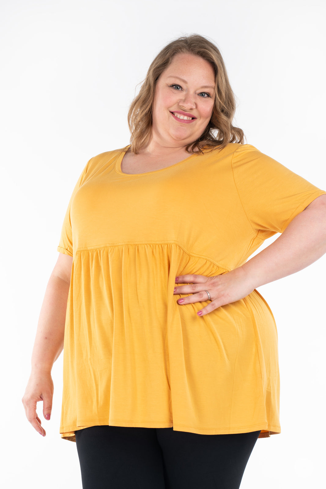 Smiling plus-size woman wearing yellow Babydoll Tee by SweetLegs Canada with babydoll silhouette and round neckline
