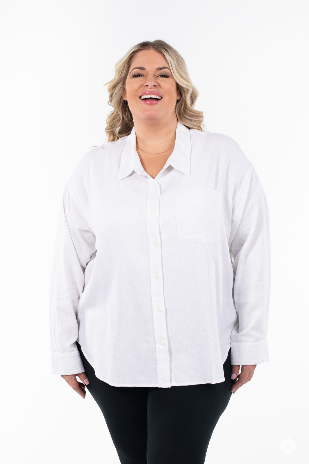Plus-size model wearing SweetTops Classic Linen Shirt in white with chest pocket and relaxed fit smiling on white background