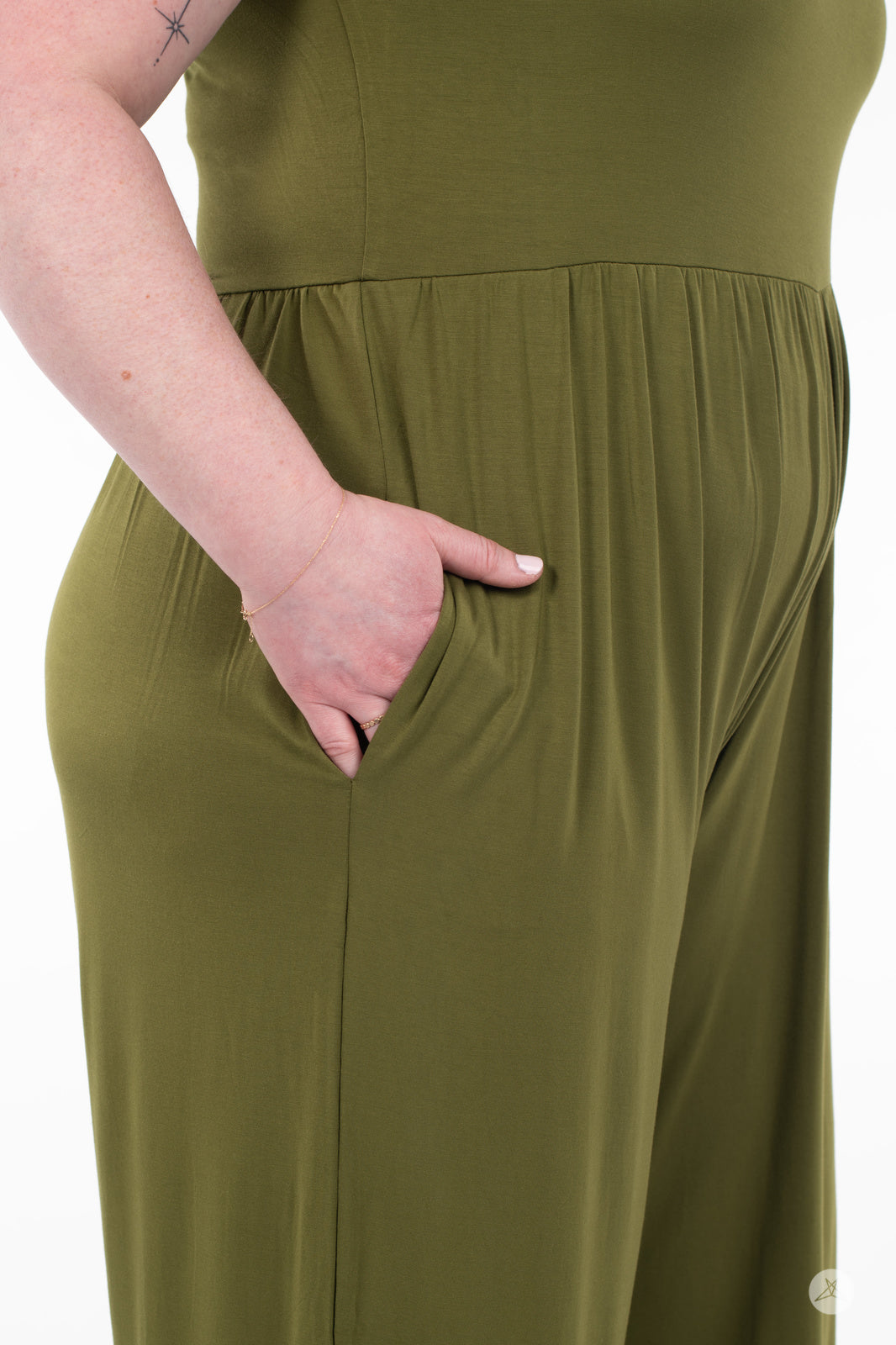Close-up of hand in side pocket on olive green SweetLegs Cropped Wide Leg Jumpsuit showing fabric texture