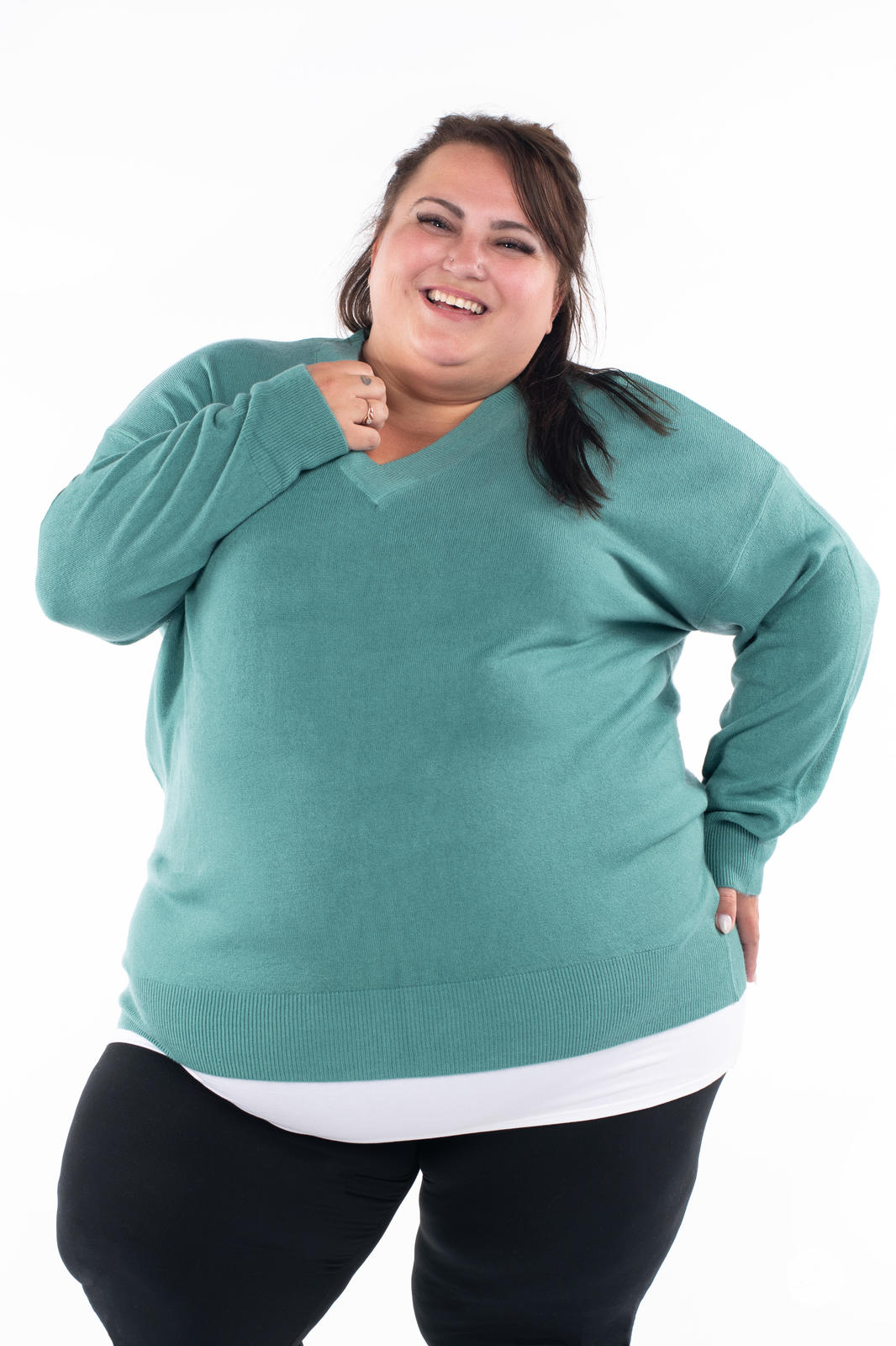 Plus size model smiling in SweetTops Soft Knit V-Neck Sweater in dusty teal with relaxed fit and ribbed cuffs and hem