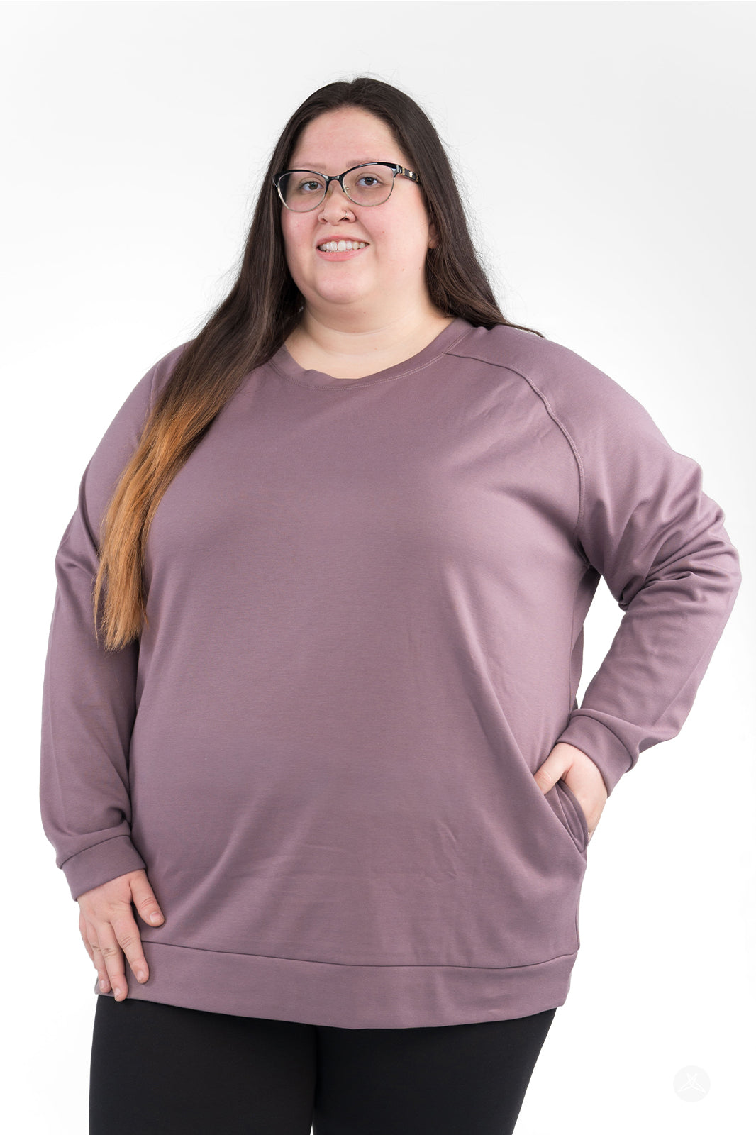 Plus-size model wearing mauve Basic Raglan Pullover by SweetLegs Canada with relaxed fit and hand in pocket, front view