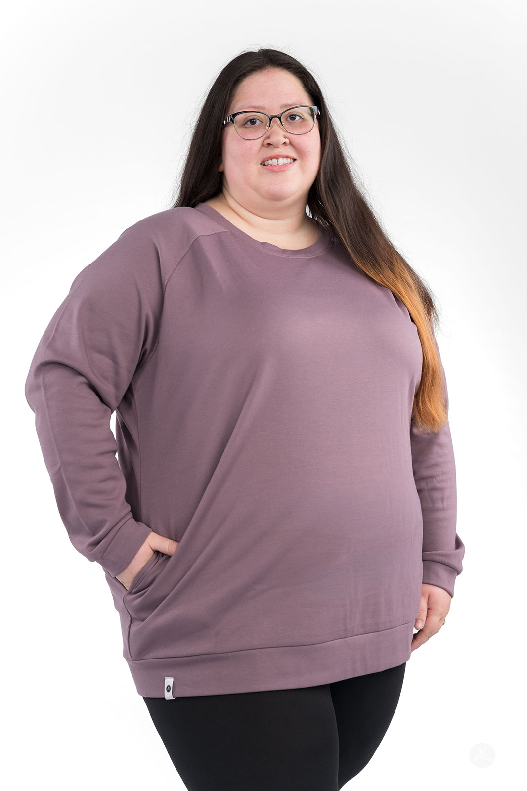 Plus-size model wearing mauve Basic Raglan Pullover by SweetLegs Canada with hands in pockets, front view