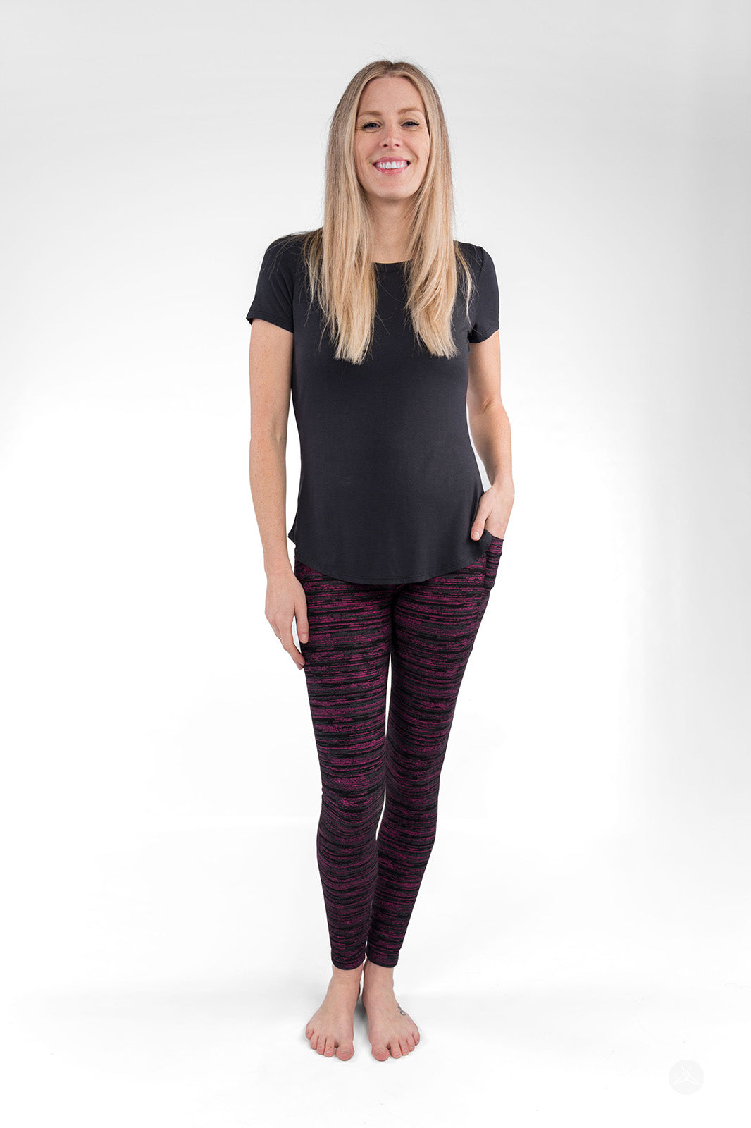 Woman wearing sweetlegs Berry Opal Pocket Leggings with hands in pockets standing barefoot against a white background