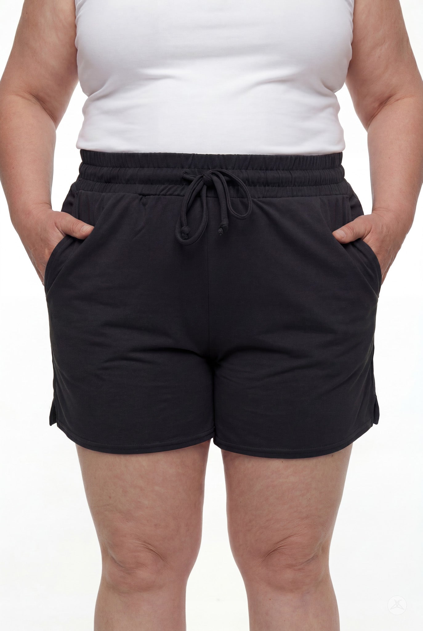Close-up of person wearing black Lounge Shorts by SweetLegs with elastic waistband and drawstring, hands in pockets