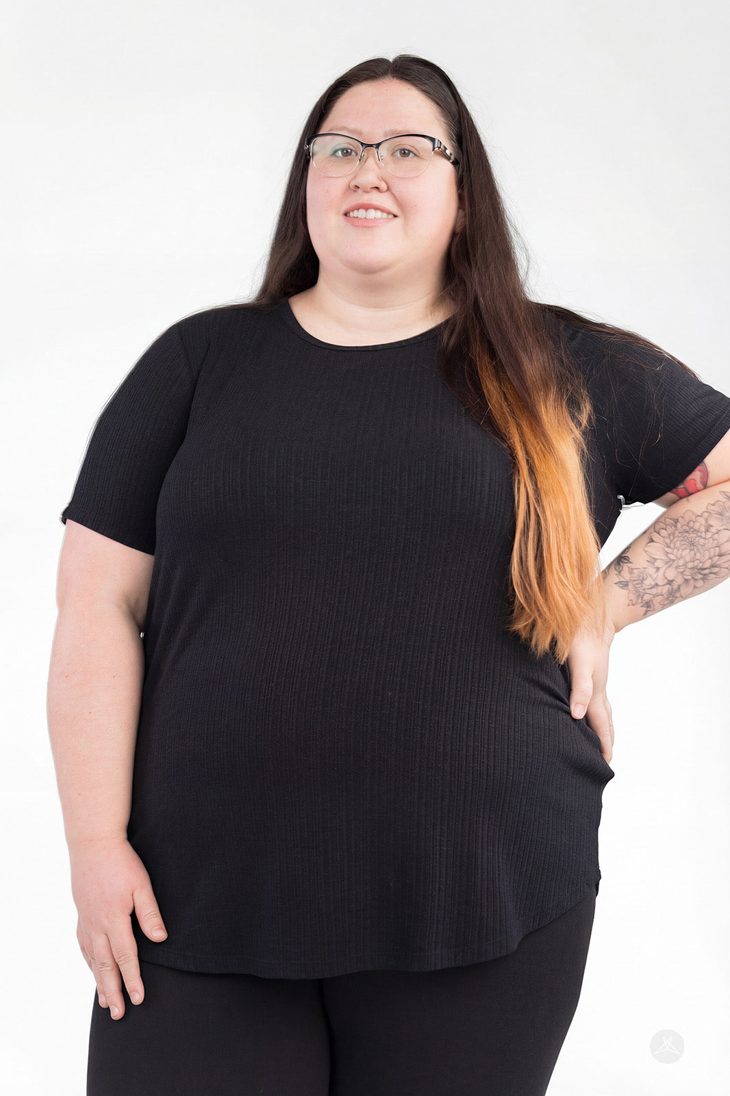 Plus-size woman wearing black The Soft Ribbed Tee by SweetLegs Canada with crew neckline and short sleeves front view
