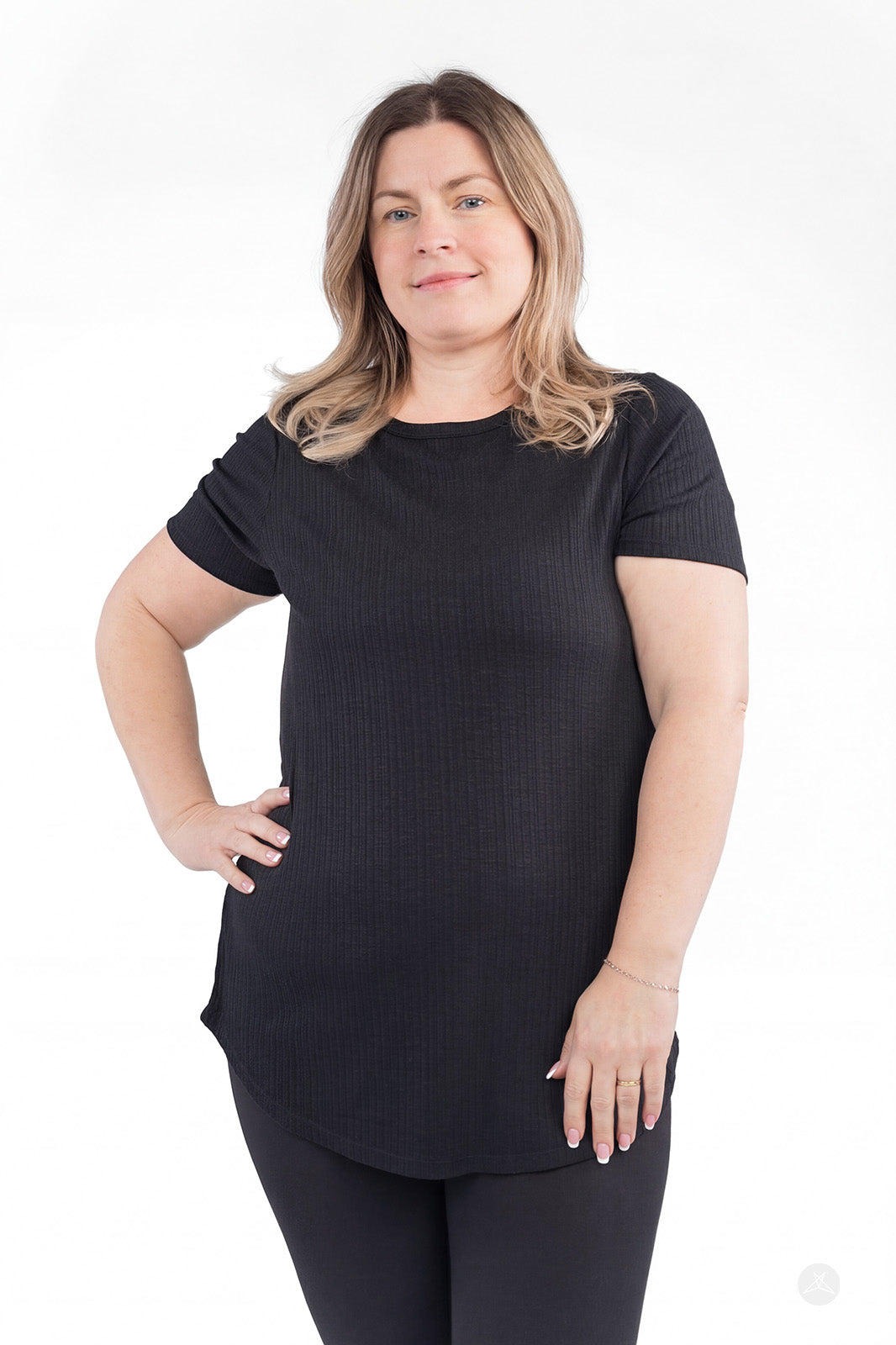 Plus-size woman wearing black The Soft Ribbed Tee by SweetLegs Canada with short sleeves and relaxed fit front view