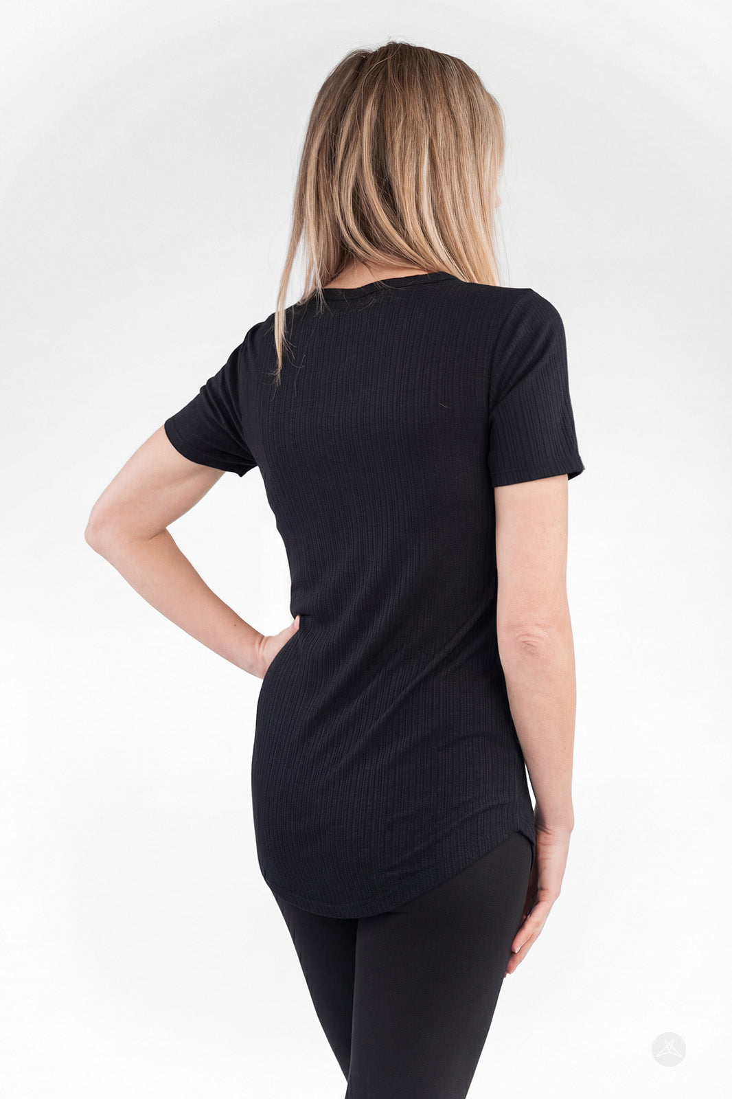 Back view of woman wearing black The Soft Ribbed Tee by SweetLegs Canada with short sleeves and rib-knit fabric
