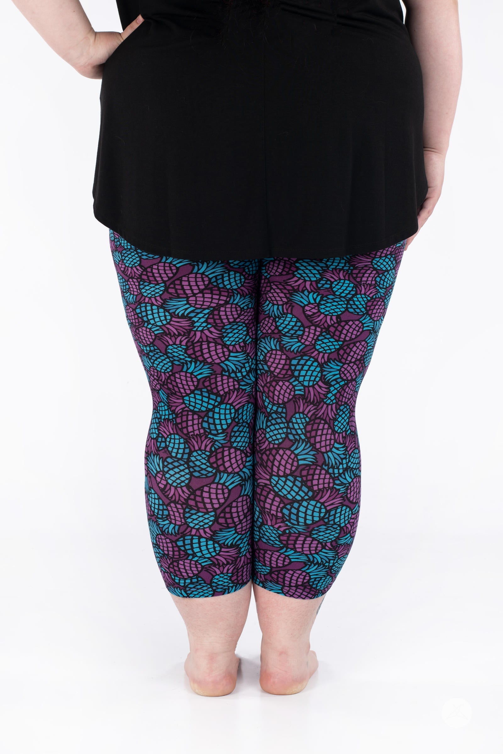 Rear view of SweetLegs Razzle Dazzle Crops in purple and turquoise pineapple print cropped leggings