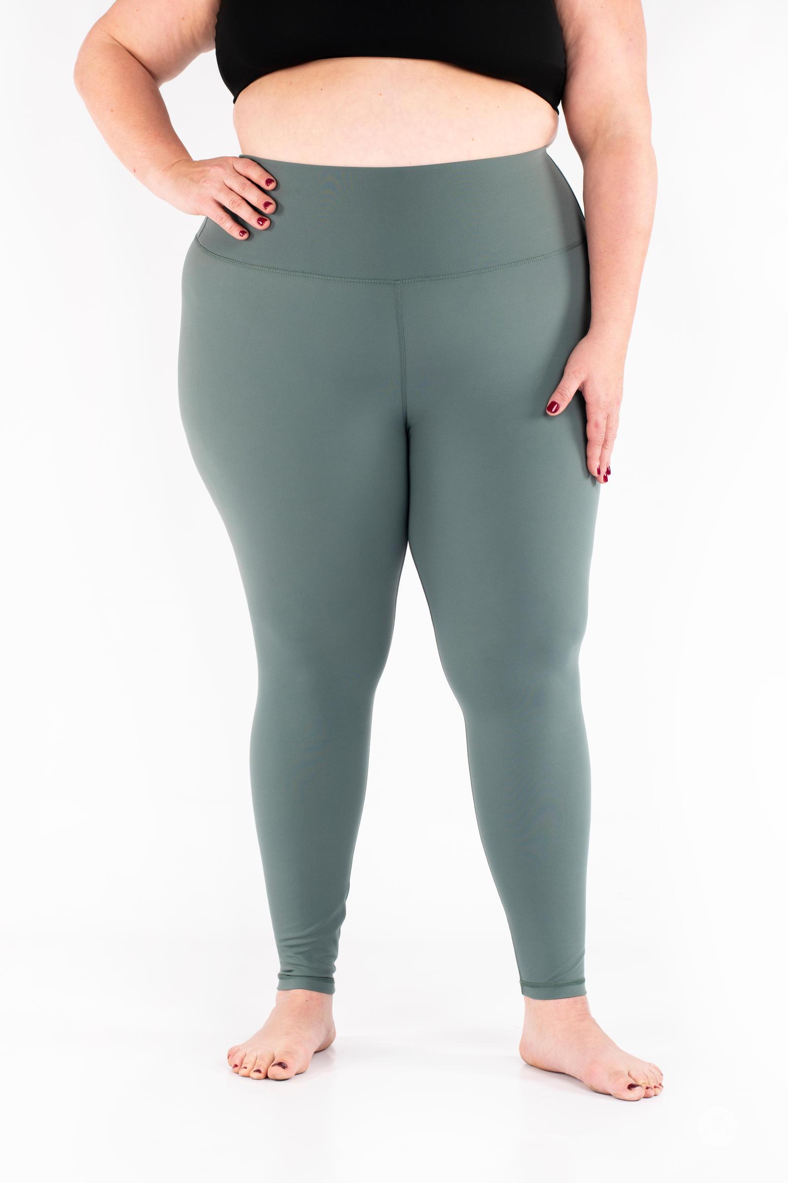 Plus-size woman wearing green Free Motion Leggings from SweetLegs Athleisure standing barefoot front view