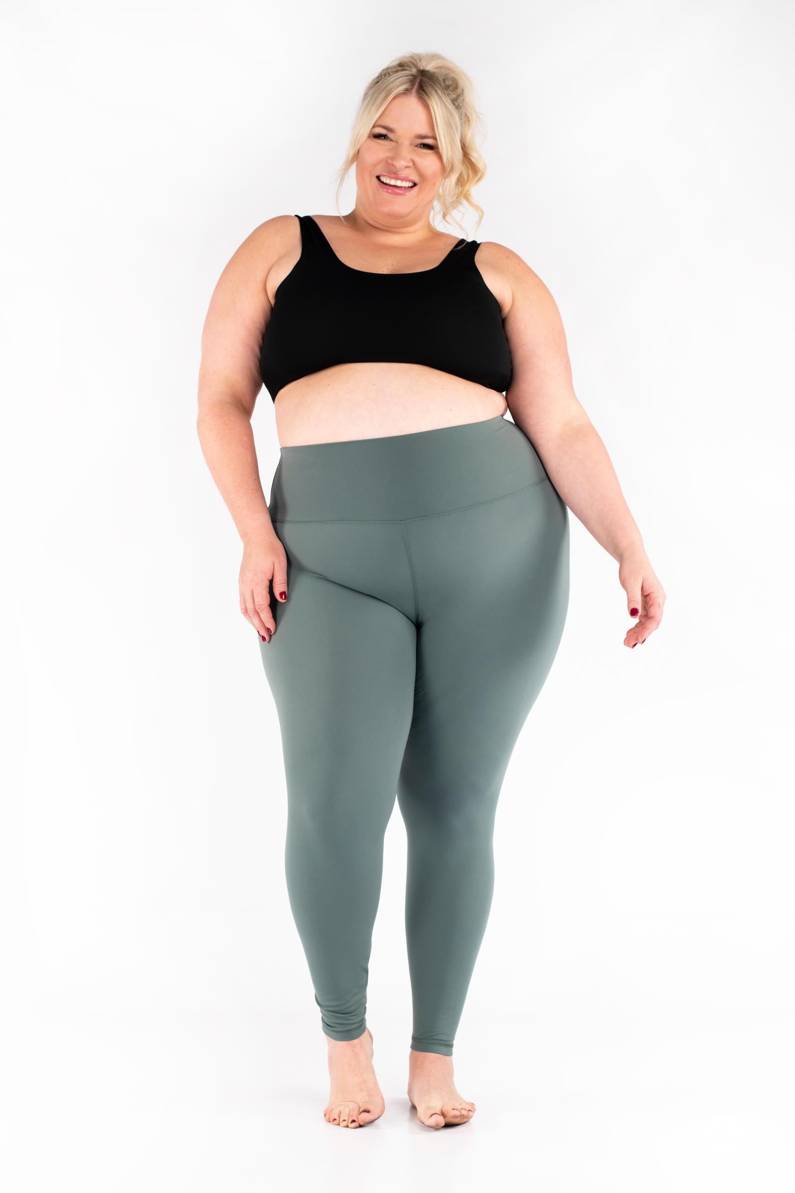 Plus-size woman wearing gray Free Motion Leggings from SweetLegs Athleisure smiling standing barefoot front view
