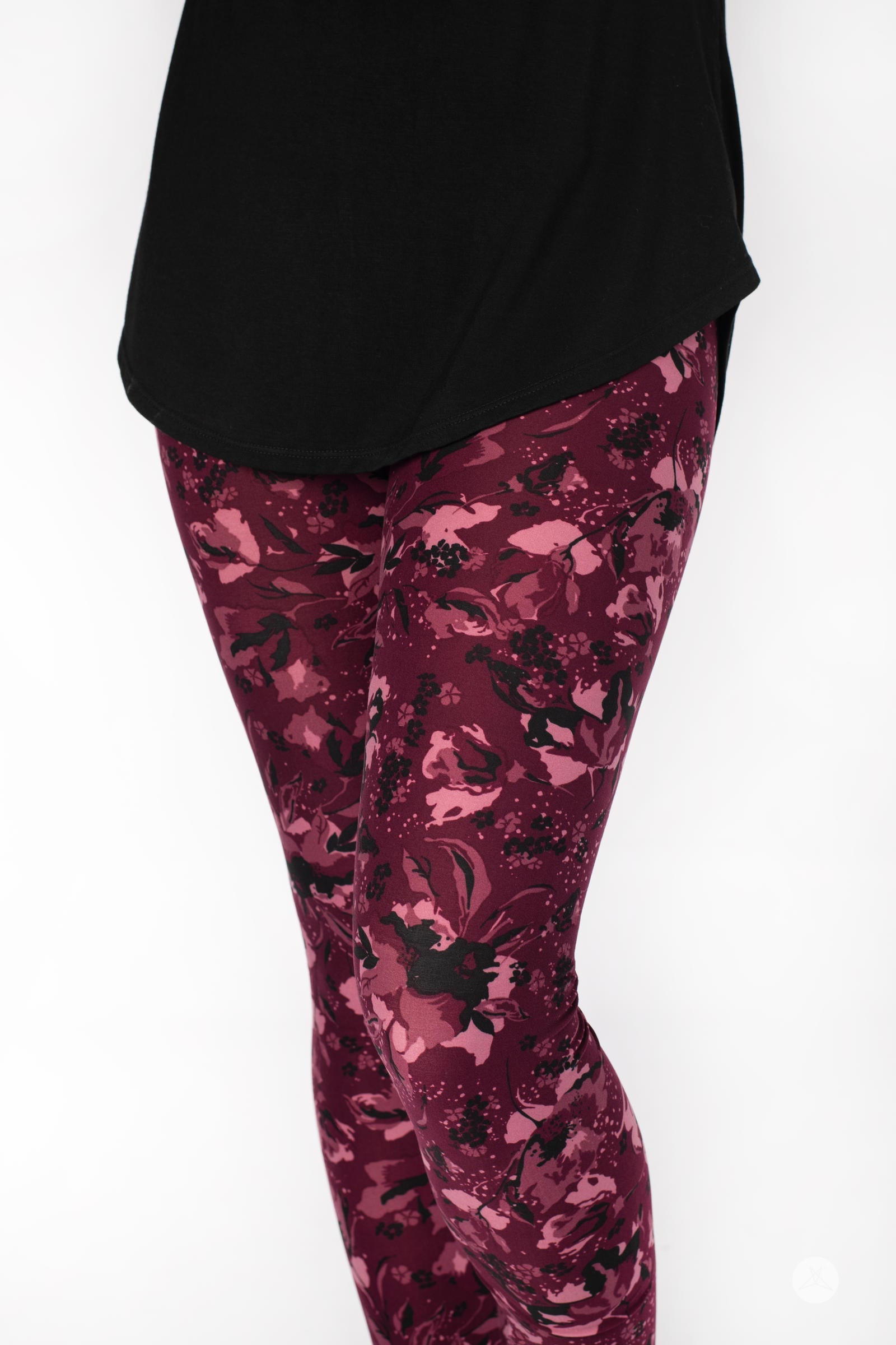 Close-up view of SweetLegs Merlot Dreams leggings with hand-drawn floral pattern in mulberry and black on maroon base