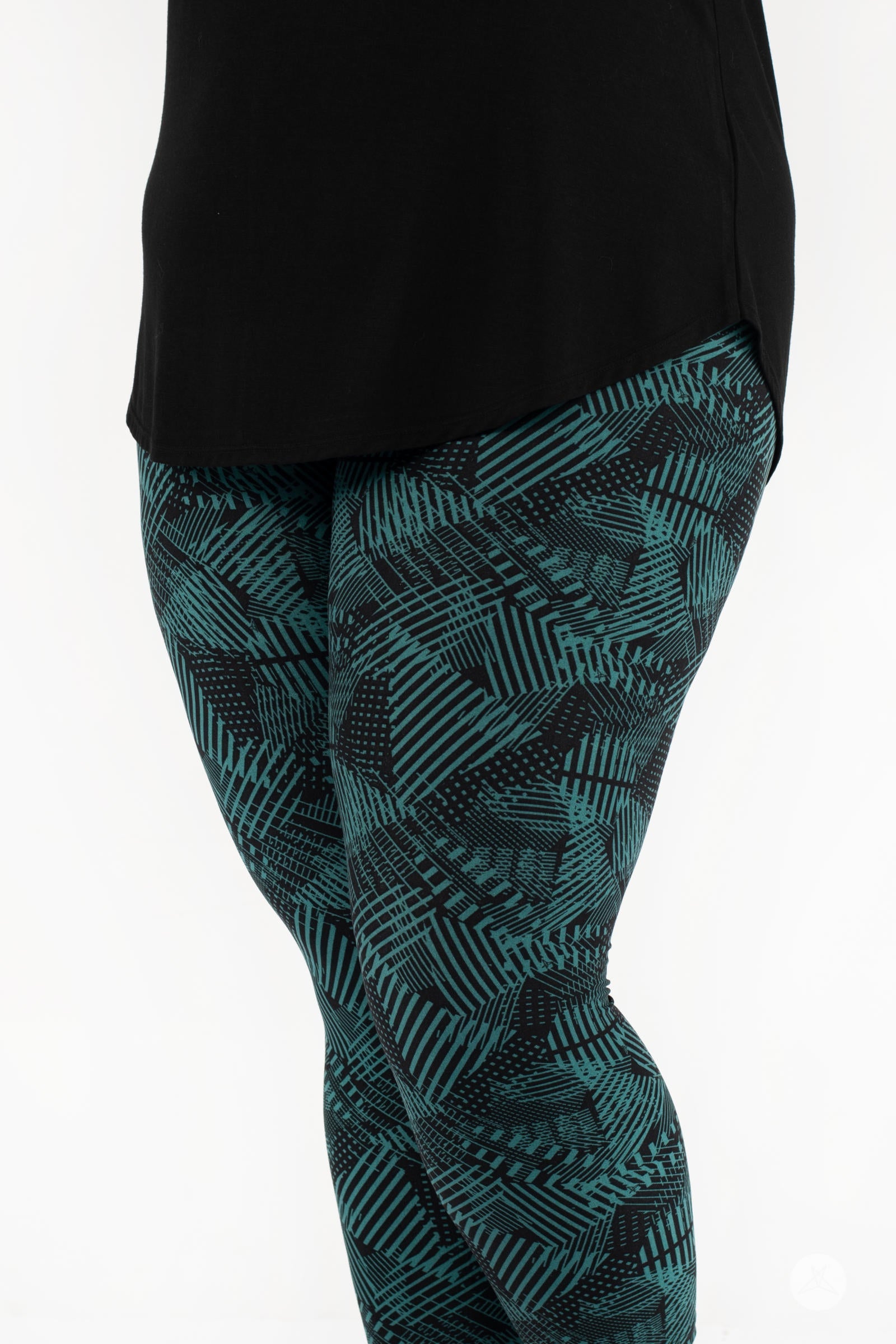 Close-up of SweetLegs Geometric Glam Crops showcasing cropped leggings with green geometric pattern and black top