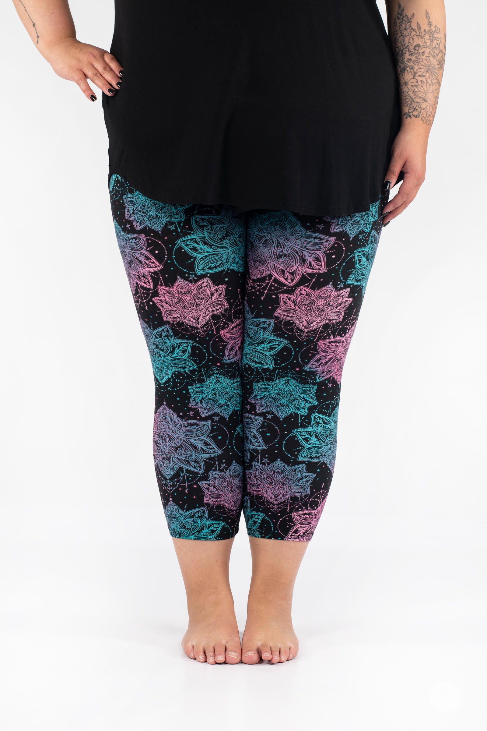 Front view of SweetLegs Everafter Crops with turquoise and pink floral geometric pattern on black background