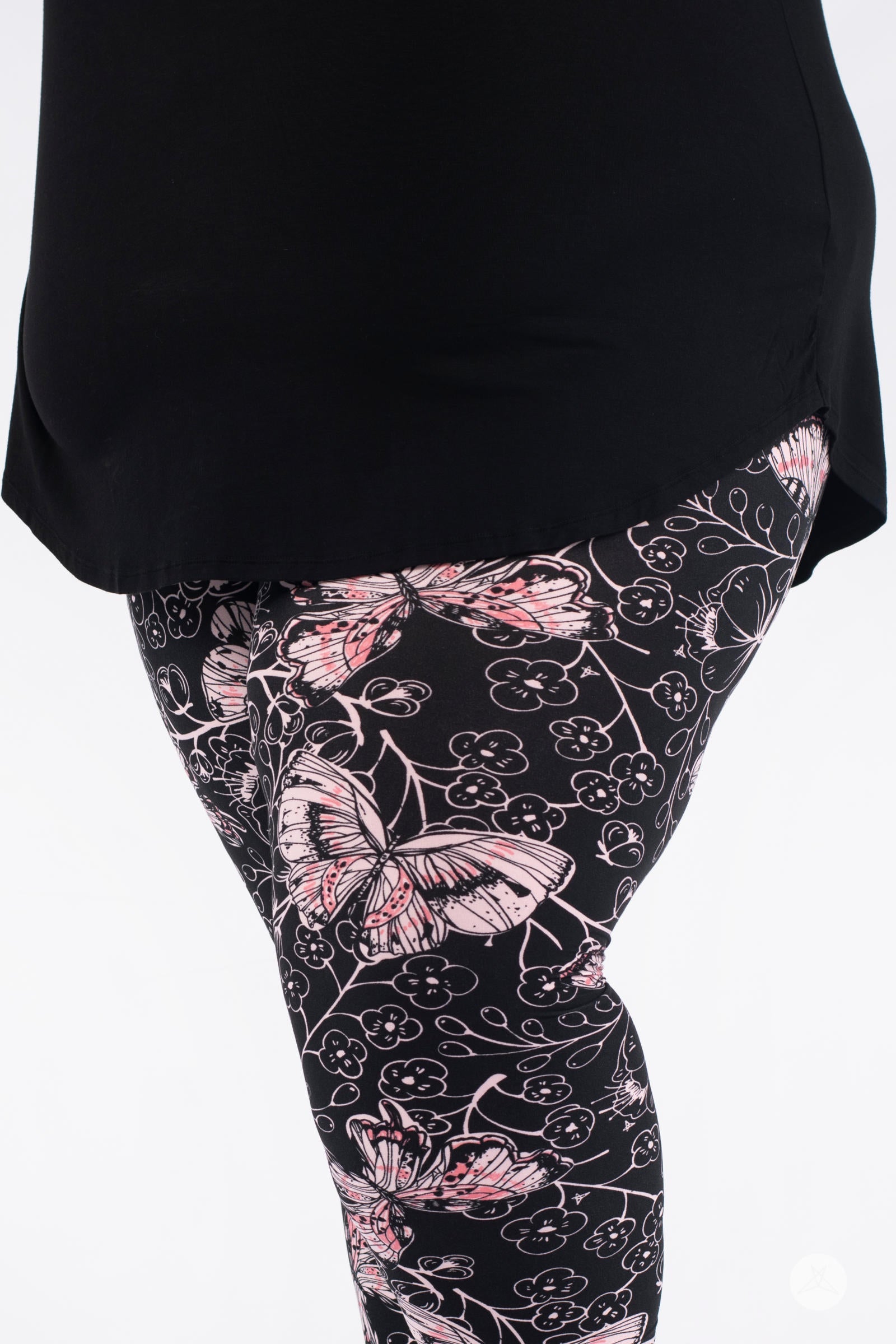 Close-up of SweetLegs Butterfly Bliss 2.0 Crops showcasing pink butterfly and floral design on black fabric