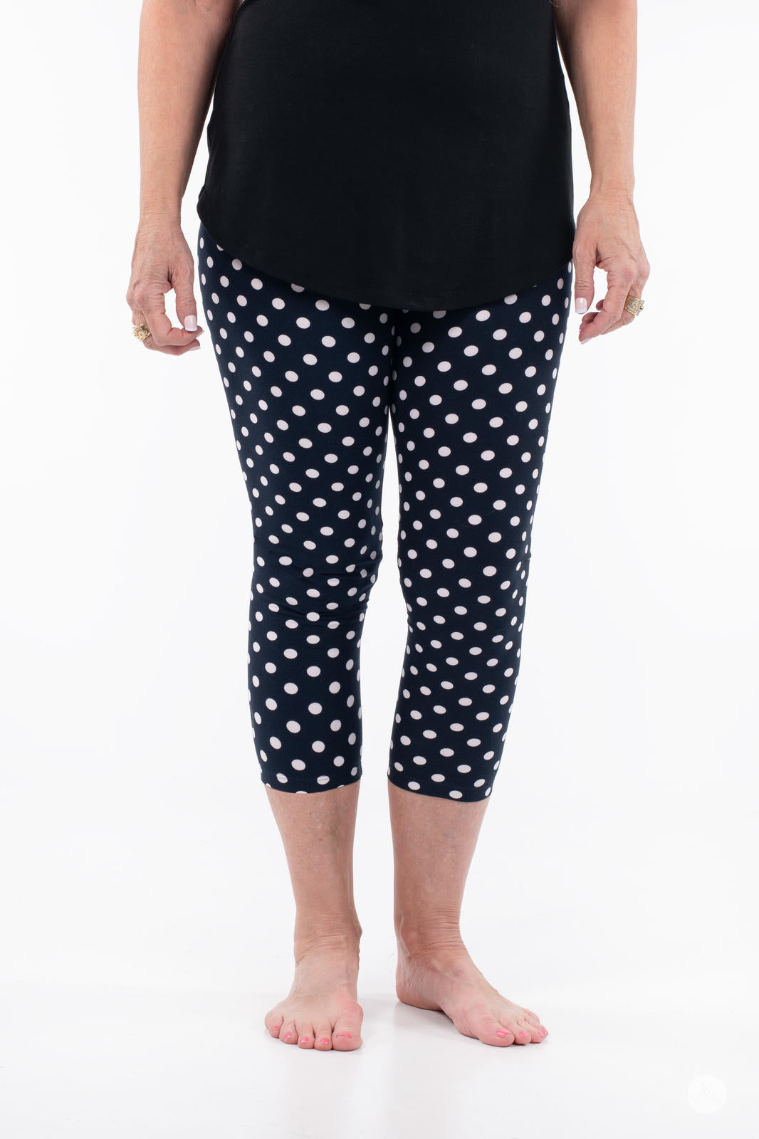 Front view of SweetLegs Get Spotted Crops in navy with white polka dots, worn with a black top on white background
