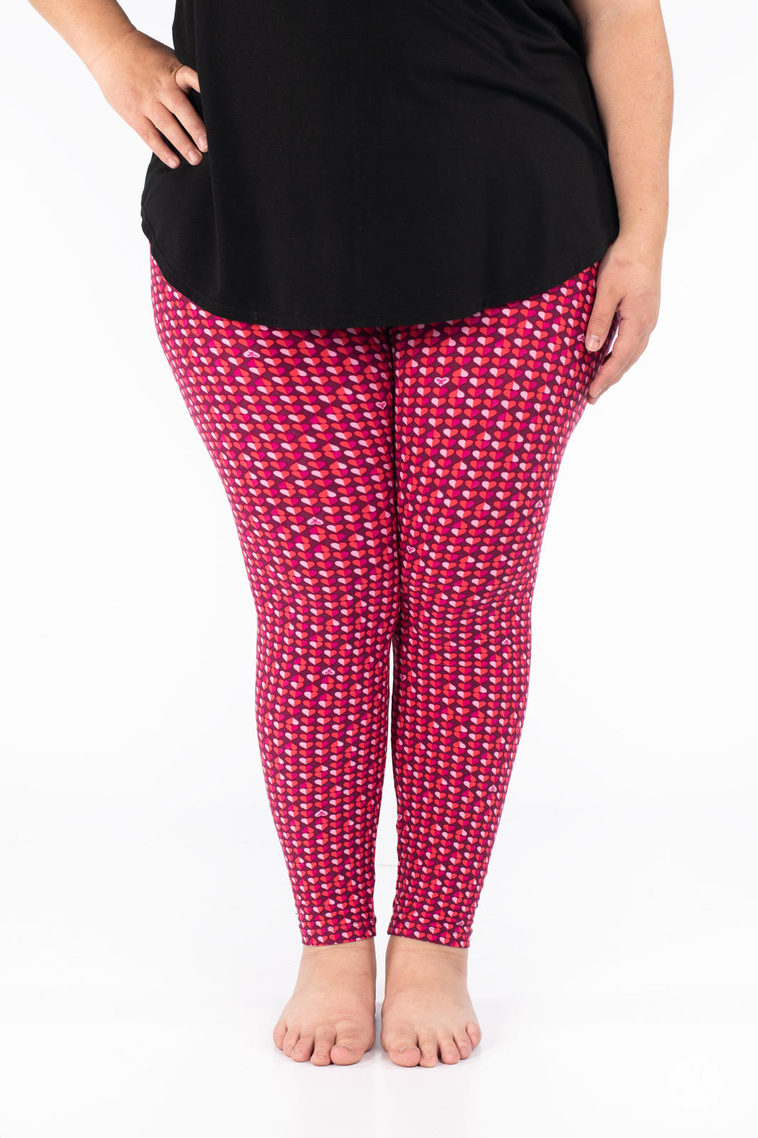 Front view of SweetLegs Lovesick leggings with a bold repeating pattern of pink and purple duo-tone hearts worn barefoot