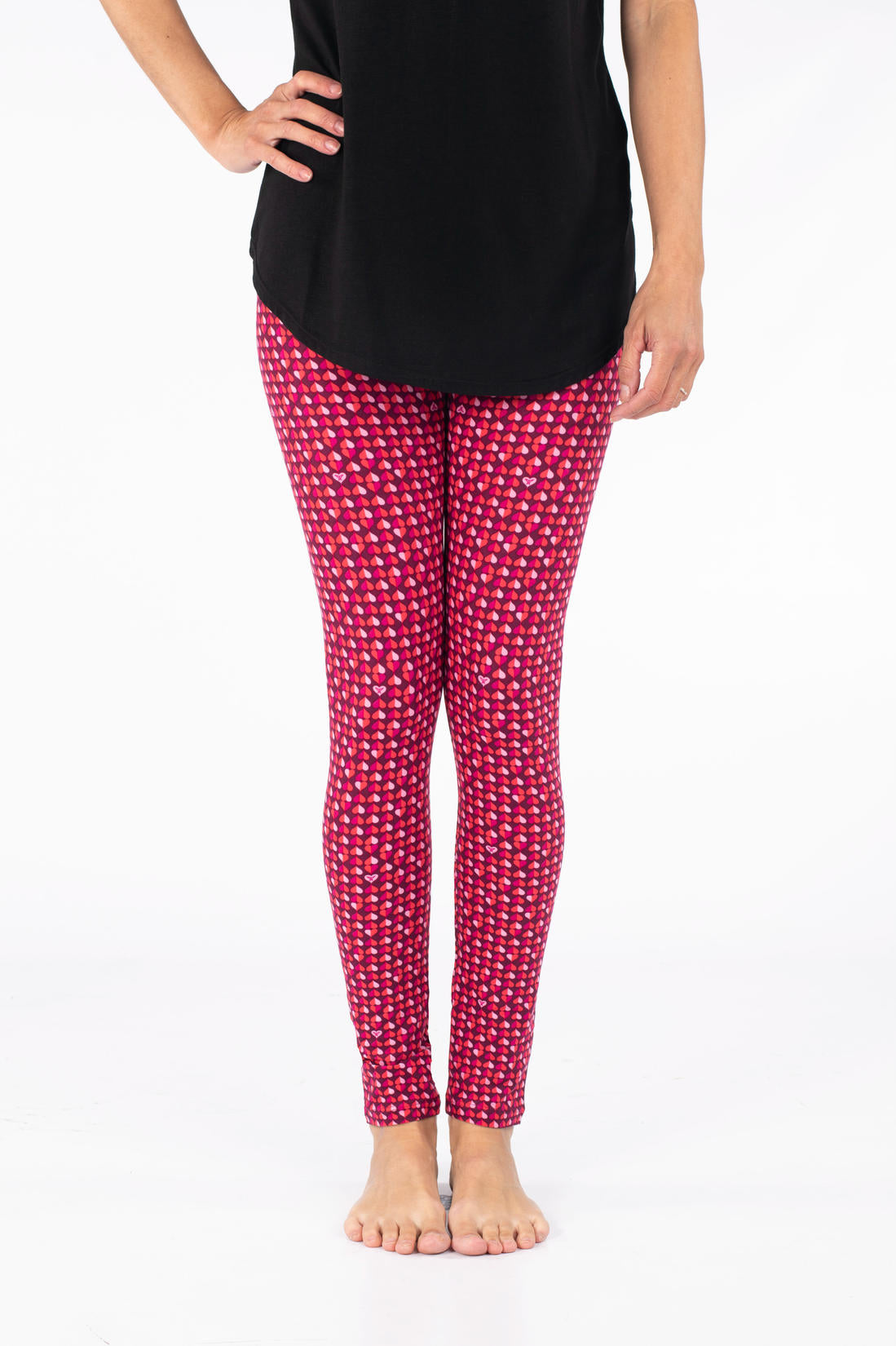 Front view of SweetLegs Lovesick leggings with repeating duo-tone pink and purple hearts worn barefoot