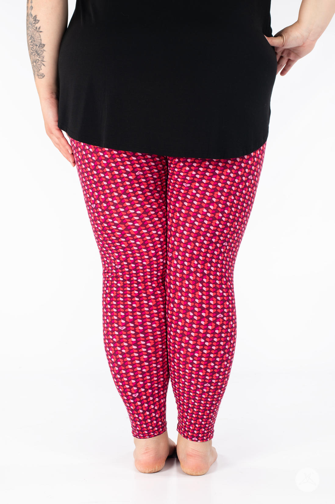 Rear view of SweetLegs Lovesick leggings with dense pink and purple duo-tone heart pattern worn barefoot