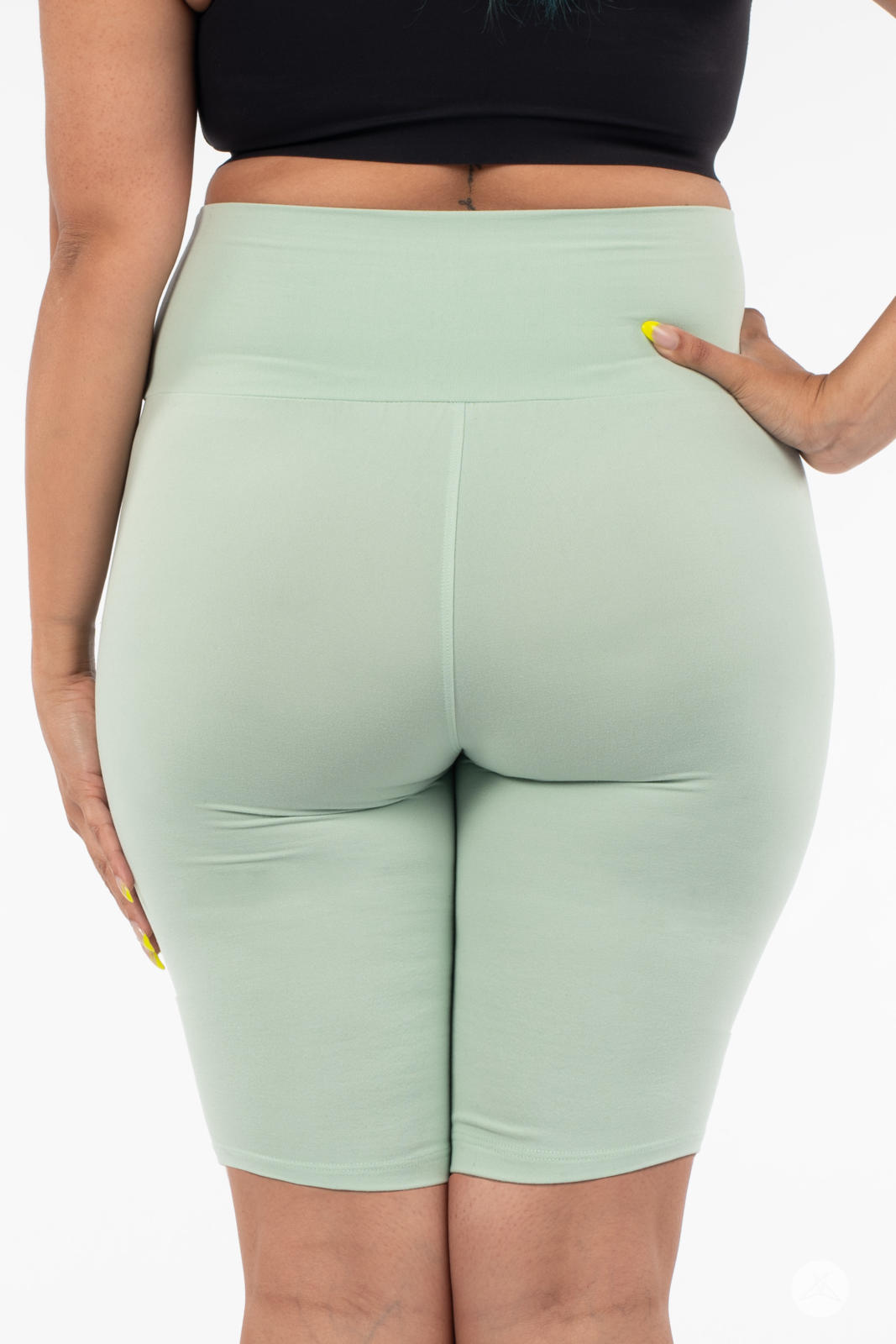 Rear view of plus-size model in SweetLegs Solid High-Waisted Biker Shorts in soft mint with a smooth waistband