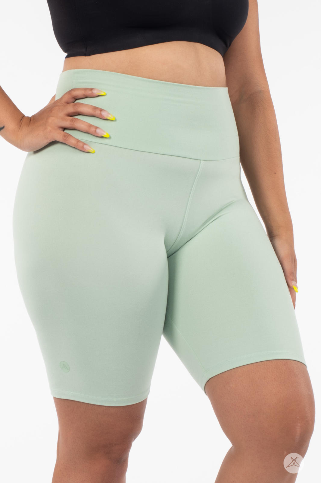 Close-up of plus-size model wearing SweetLegs Solid High-Waisted Biker Shorts in soft mint with a smooth waistband