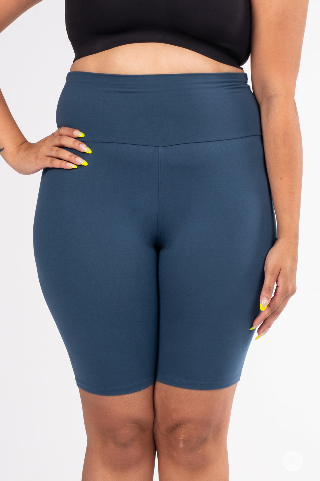 Front view of plus-size model wearing SweetLegs Solid High-Waisted Biker Shorts in deep blue with a smooth waistband