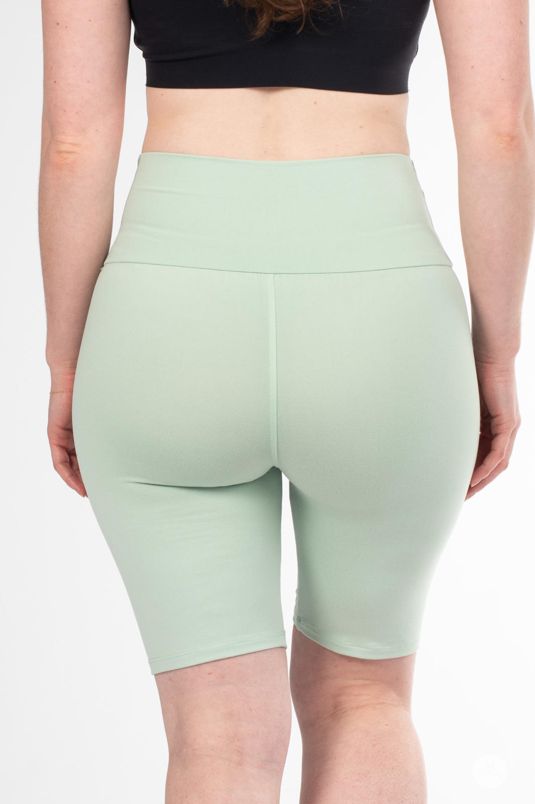 Rear view of woman wearing SweetLegs Solid High-Waisted Biker Shorts in soft mint with a smooth wide waistband