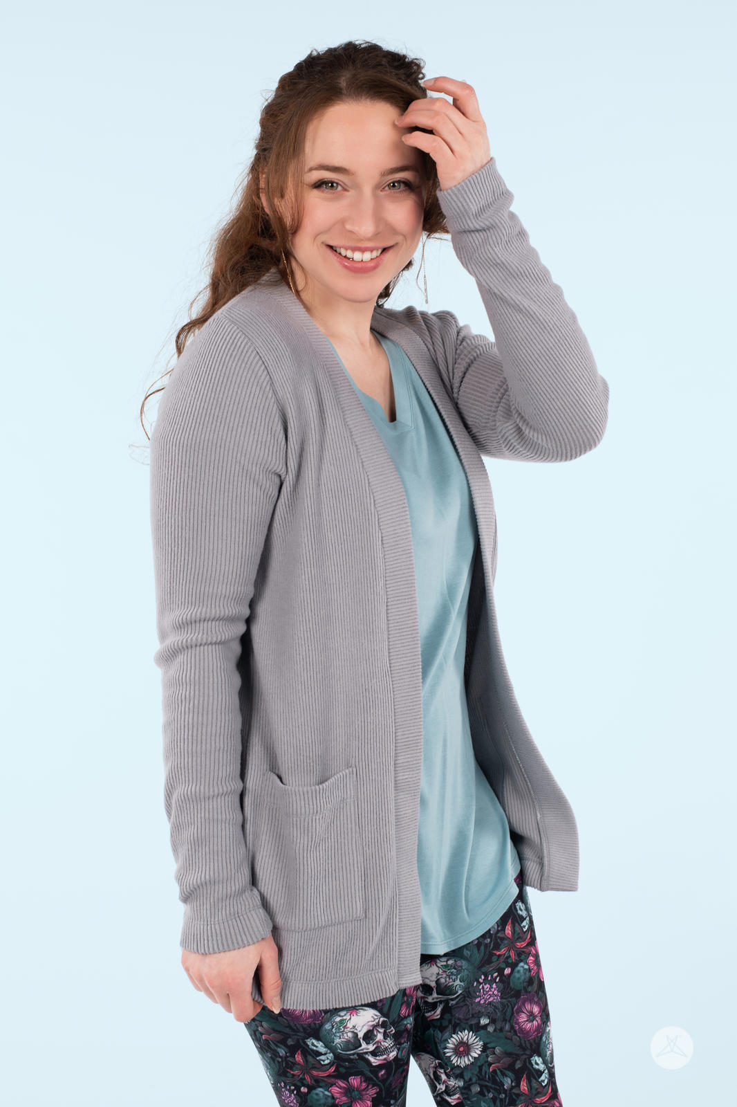 Smiling woman wearing SweetLegs Canada Ribbed Comfort Cardigan in dusty grey with front pockets and relaxed open fit