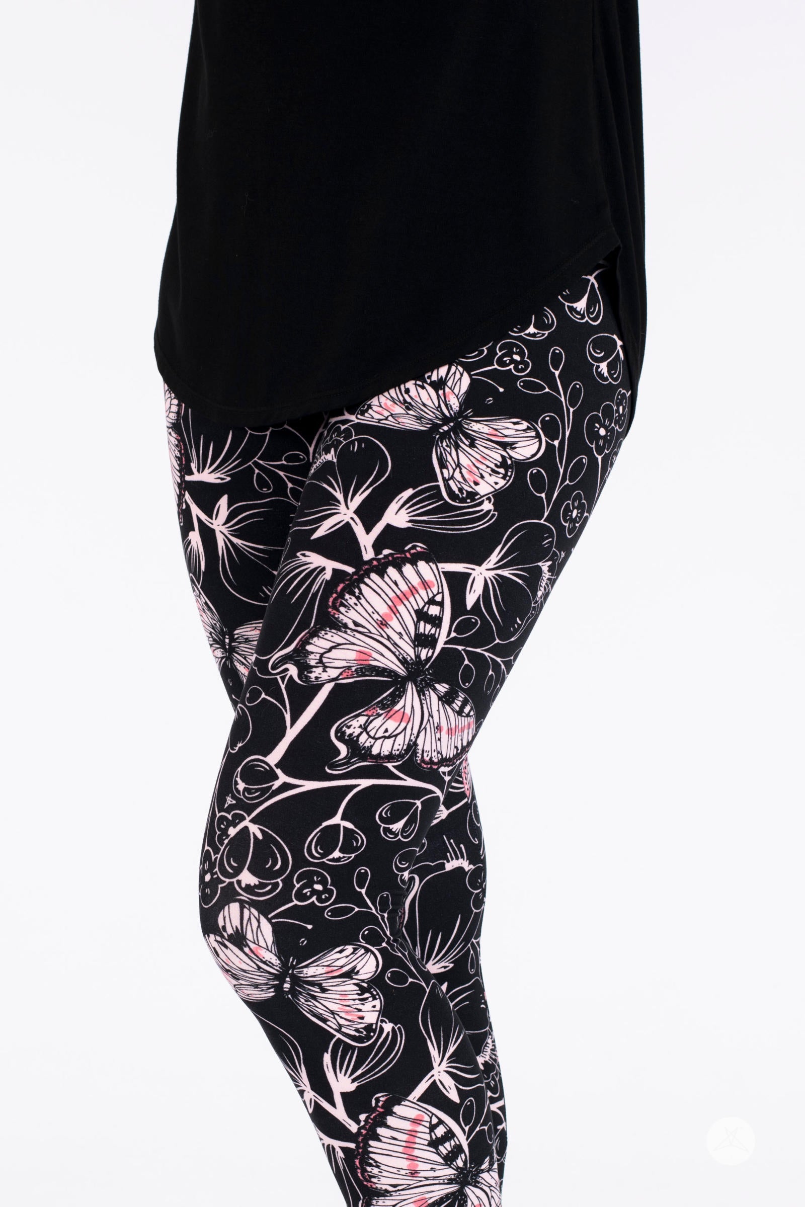 SweetLegs Butterfly Bliss 2.0 Crops with pink and white butterfly pattern on black fabric shown on model's legs