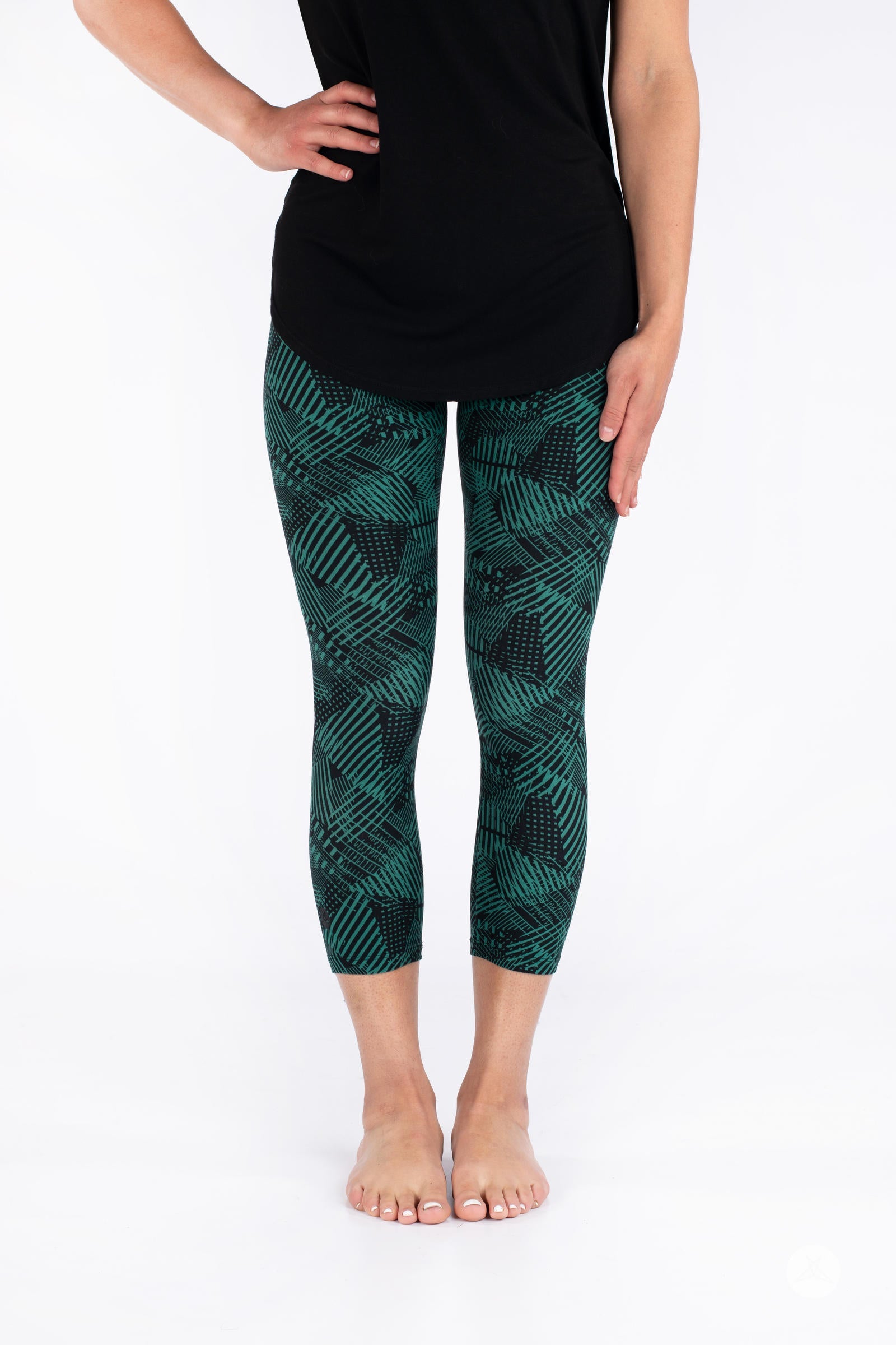 Front view of SweetLegs Geometric Glam Crops featuring cropped leggings with green and black geometric pattern