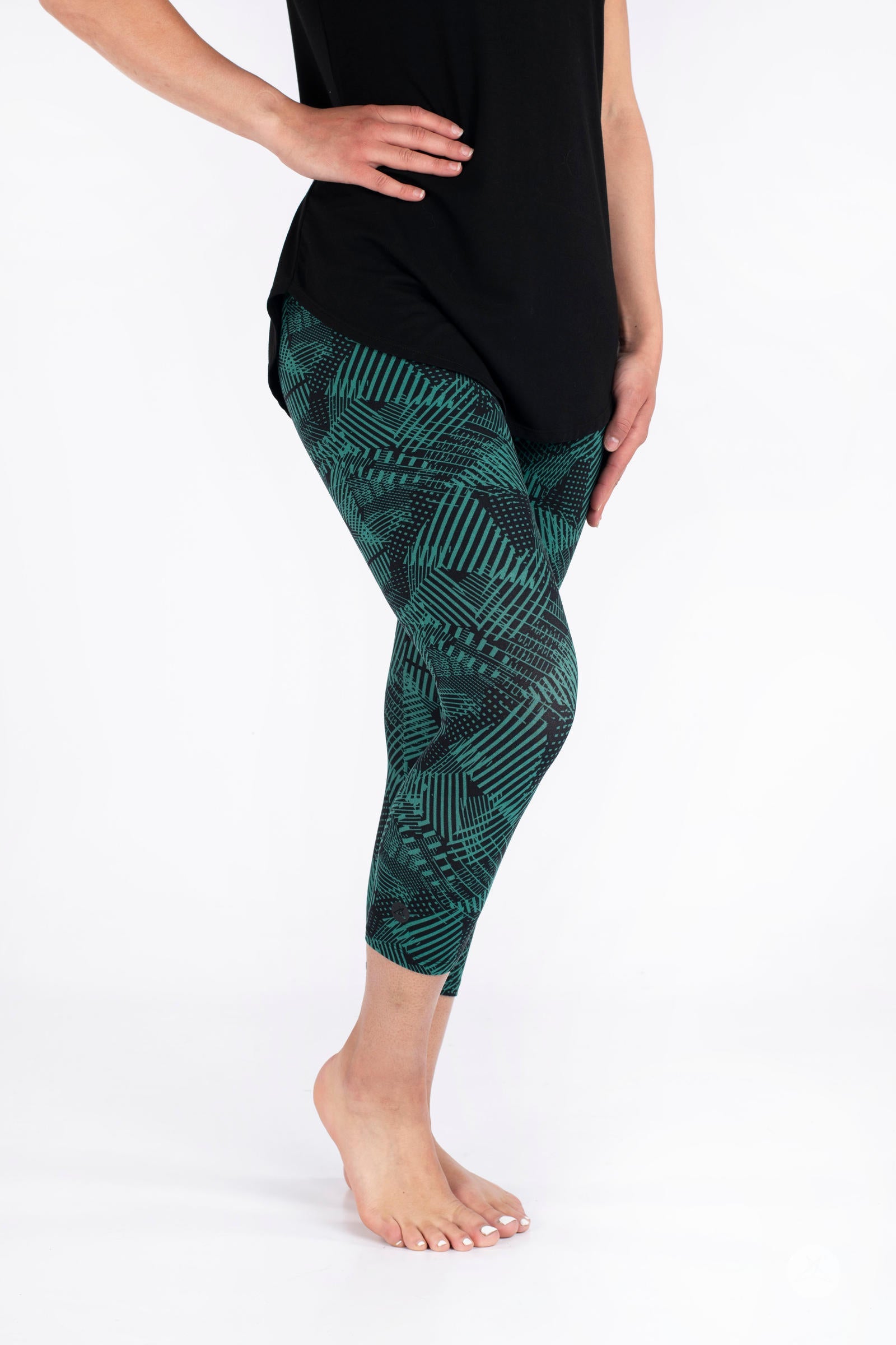 Side view of model wearing SweetLegs Geometric Glam Crops with green abstract patterned cropped leggings