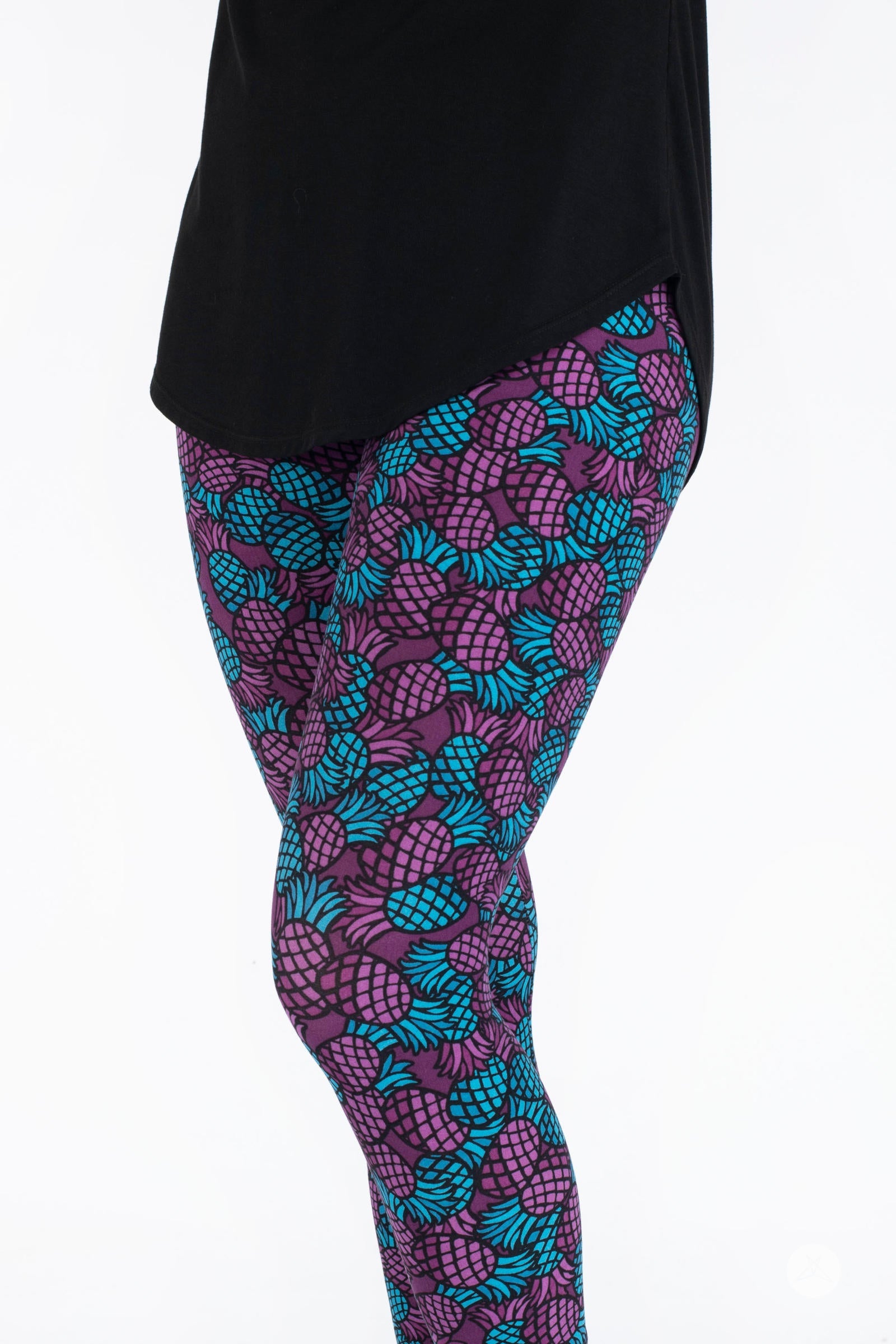 Side view of SweetLegs Razzle Dazzle Crops with vibrant blue and purple pineapple pattern on cropped leggings