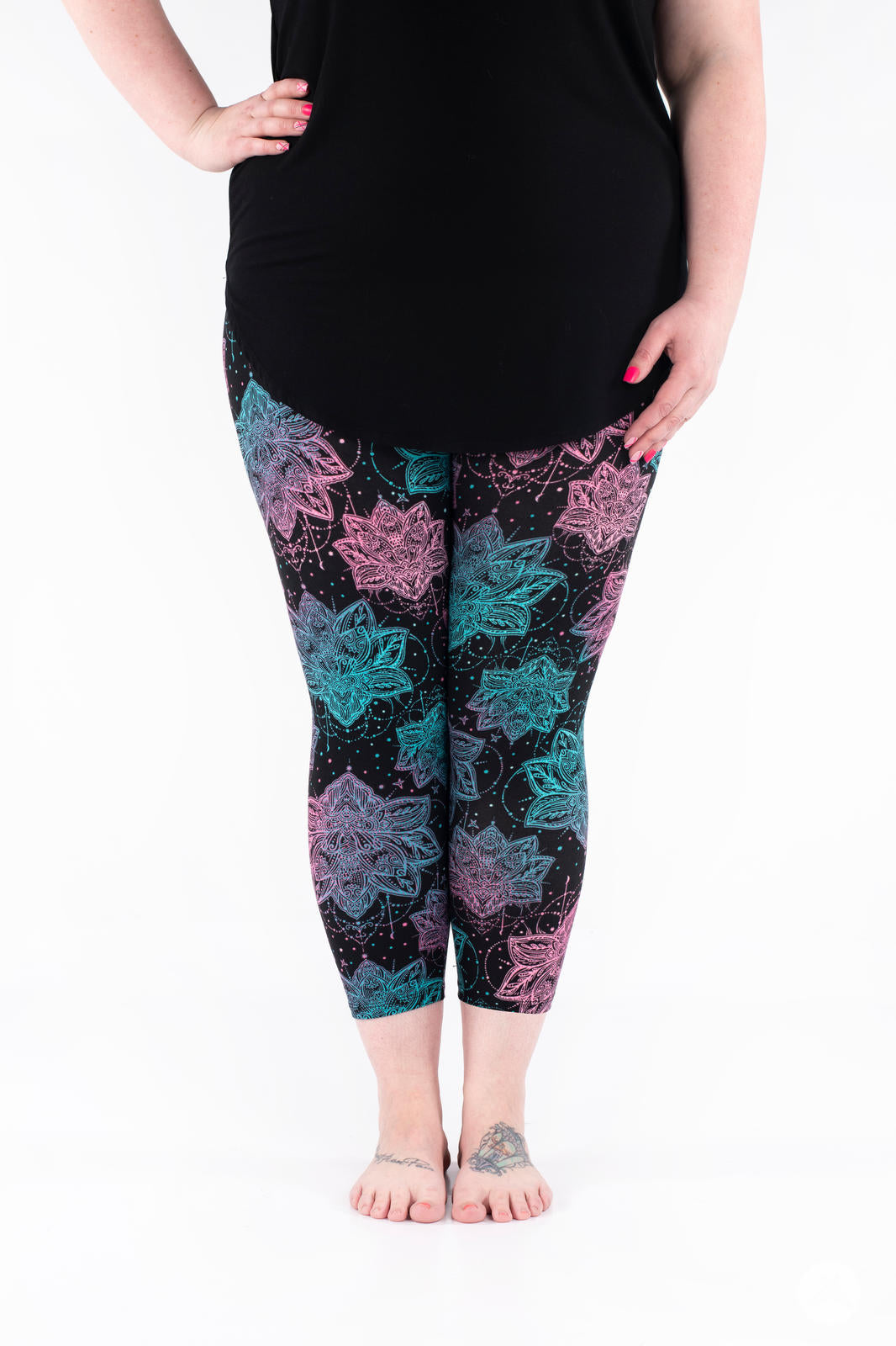 Front view of SweetLegs Everafter Crops with blue and pink floral patterns on black background worn by model