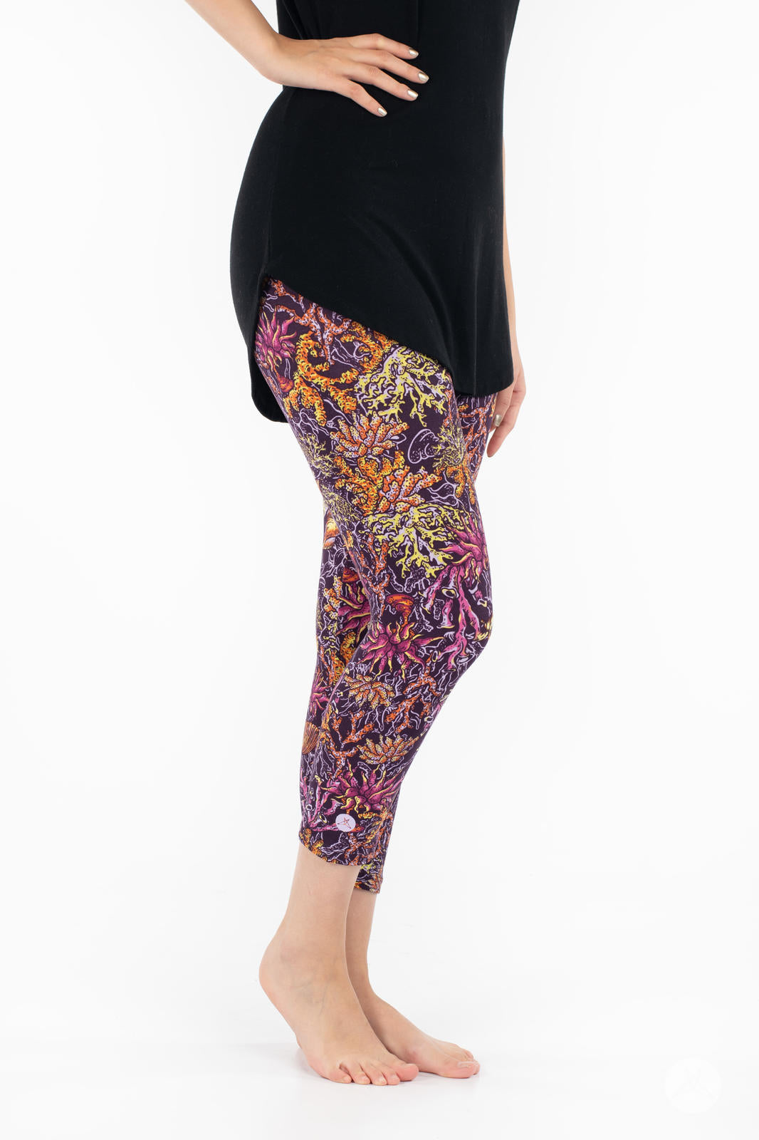 Side view of SweetLegs Coral Cove Crops featuring vibrant coral reef pattern cropped above the ankle for warm weather style