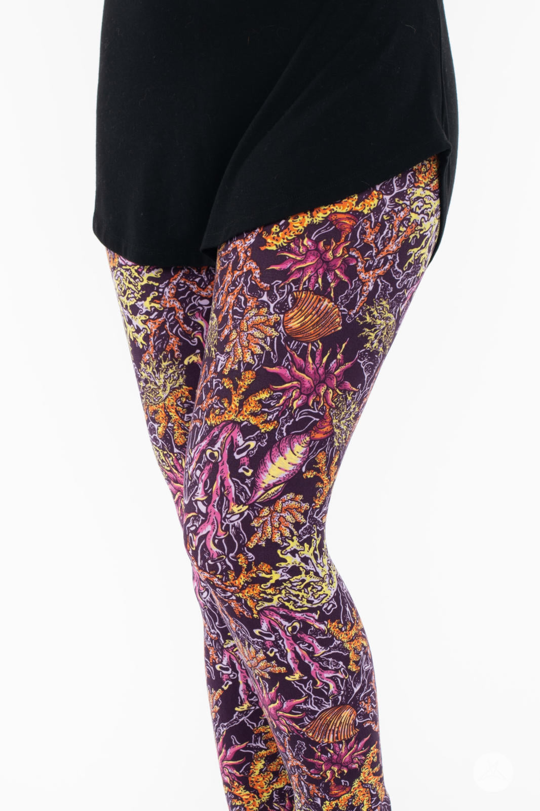 Close-up of SweetLegs Coral Cove Crops featuring intricate sea life patterns in vibrant purple and orange tones