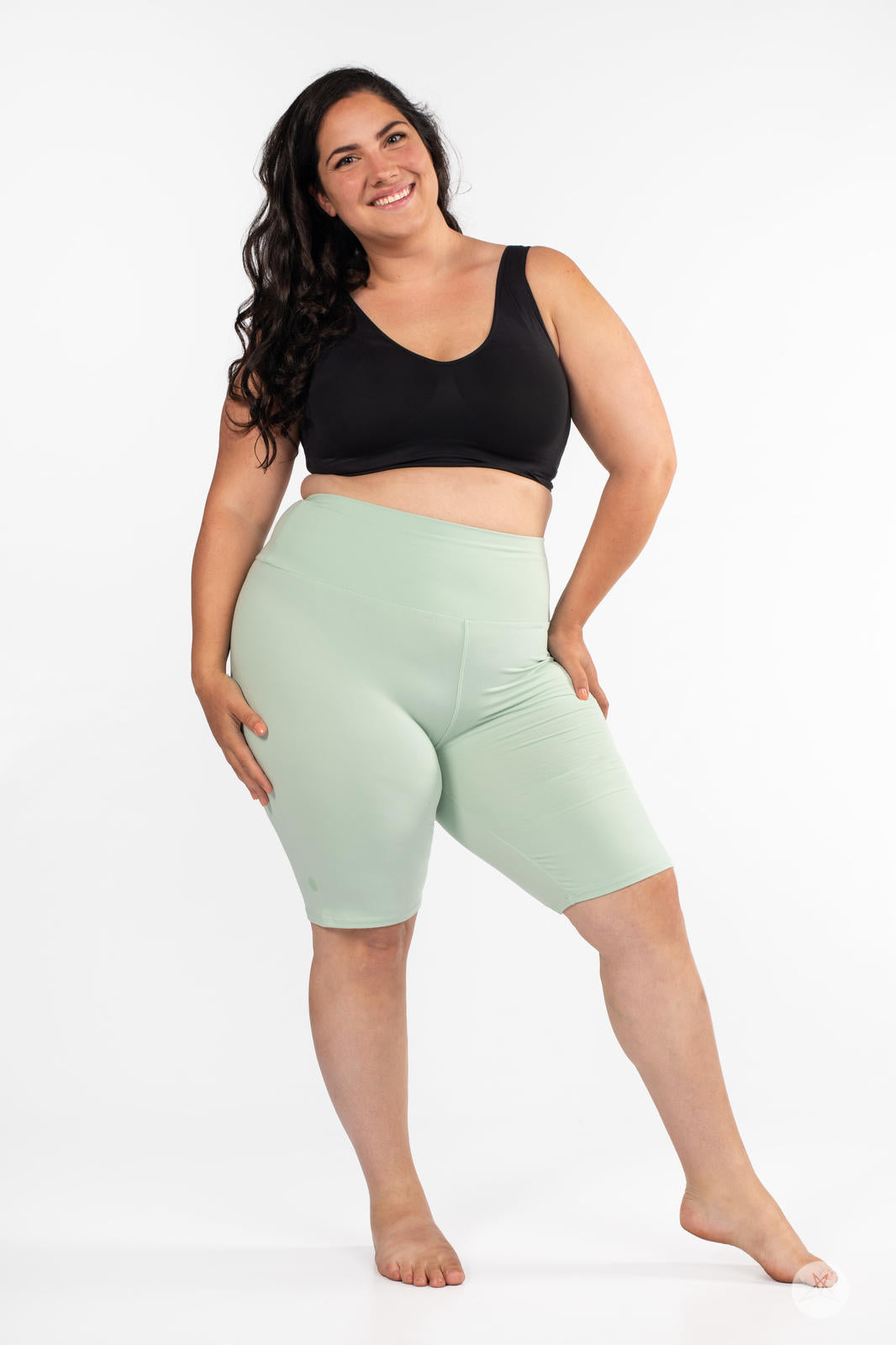 Plus-size model in SweetLegs Solid High-Waisted Biker Shorts in soft mint with a smooth supportive waistband