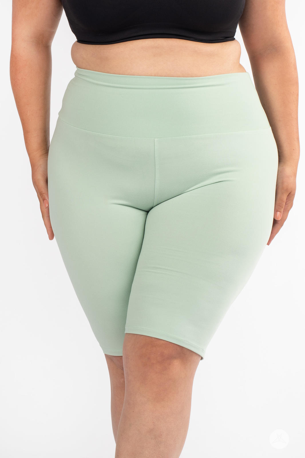 Front view of plus-size model wearing SweetLegs Solid High-Waisted Biker Shorts in soft mint with a smooth waistband
