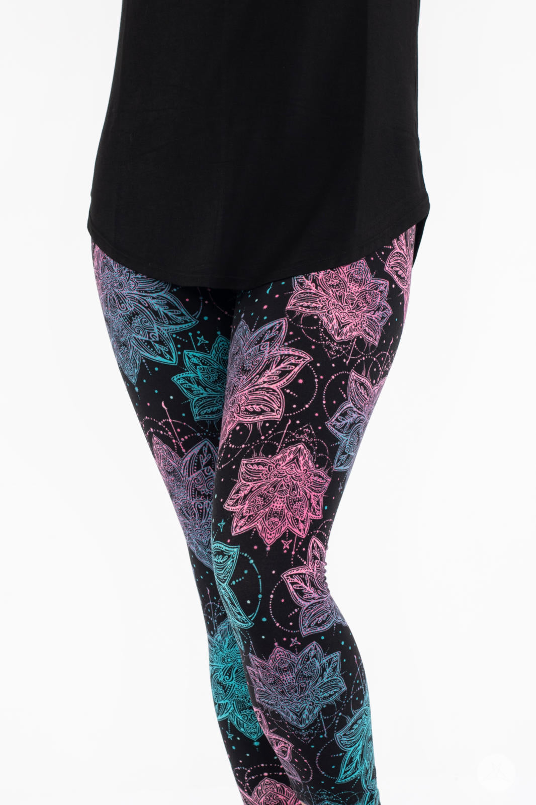Close-up of SweetLegs Everafter Crops featuring pink and blue floral geometric pattern on black background