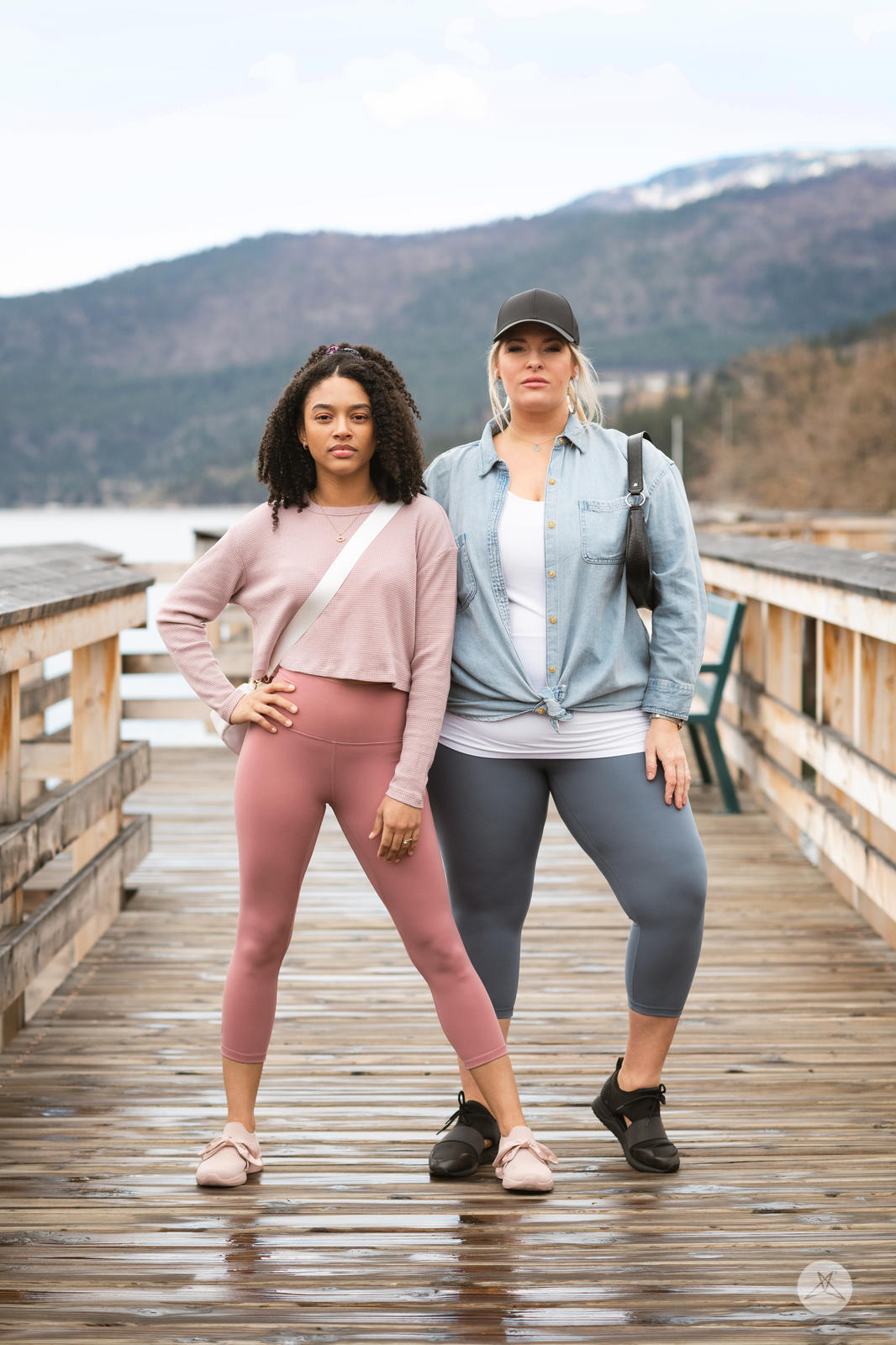 Two women standing on wooden dock wearing Free Motion Crops by Athleisure SweetLegs collection outdoors
