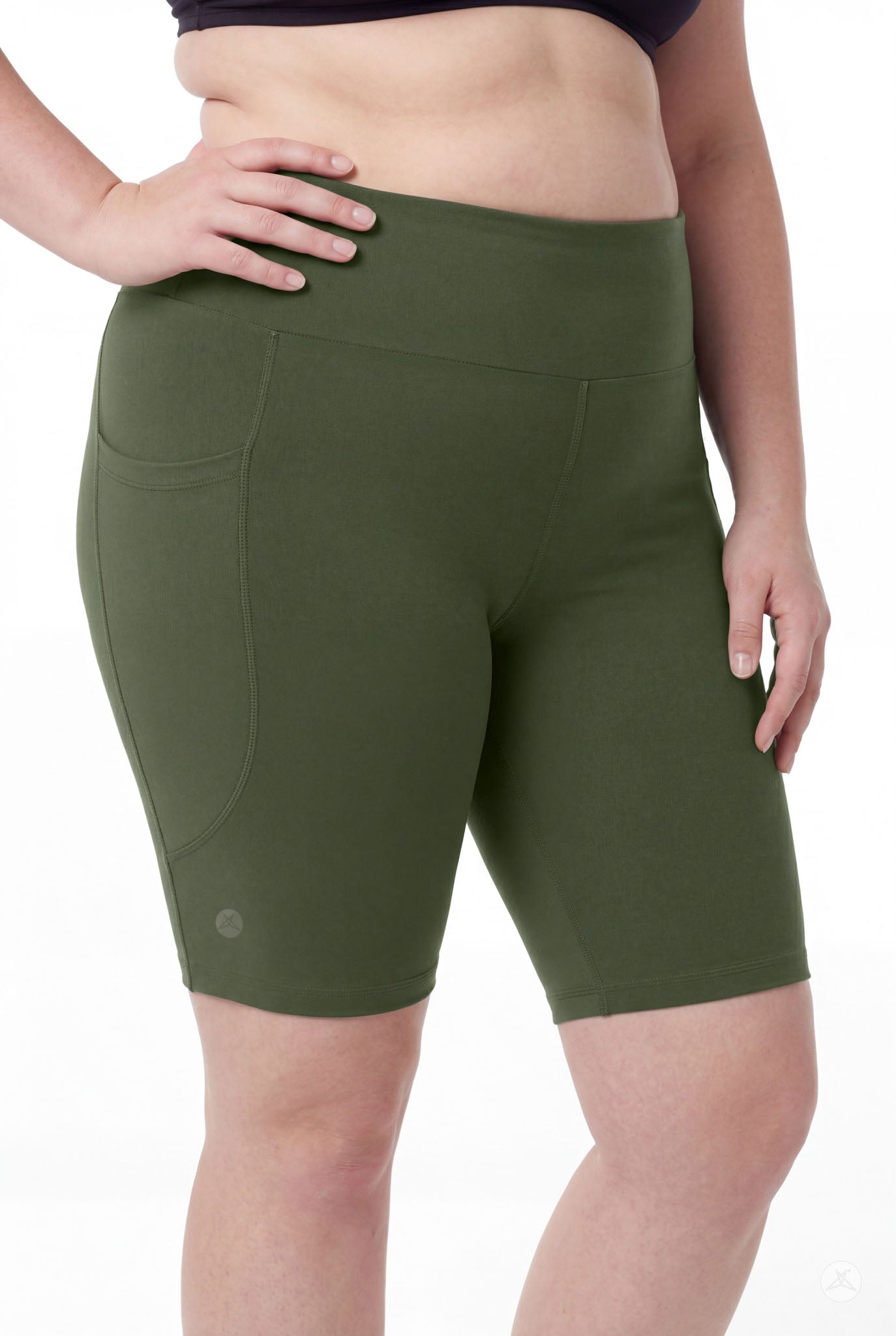Plus size model wearing SweetLegs Cedar High-Waisted Pocket Biker Shorts in green with black top front view close-up