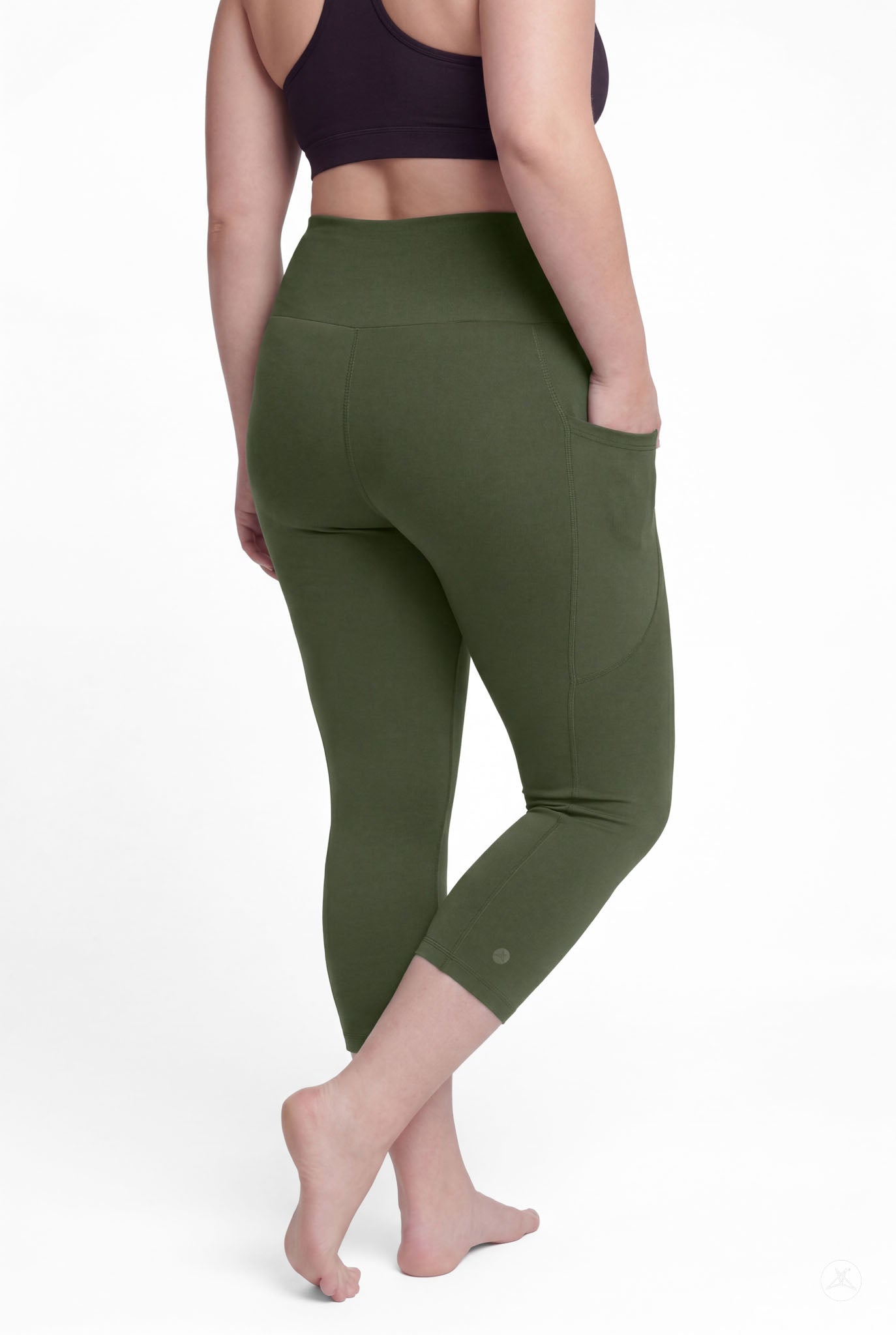 Woman barefoot showing back view wearing SweetLegs Cedar High-Waisted Pocket Crops in olive green with hand in pocket