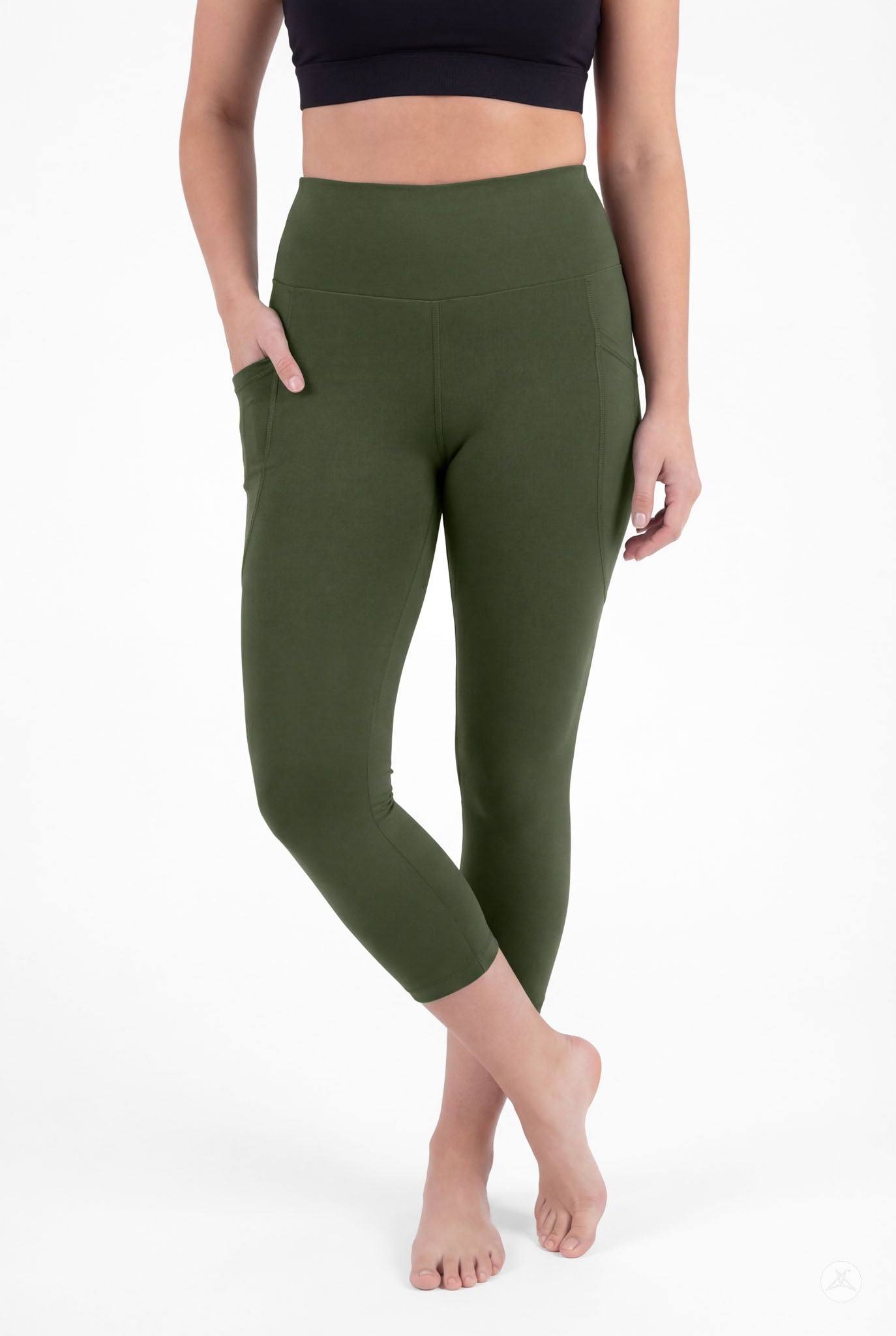 Woman wearing SweetLegs Cedar High-Waisted Pocket Crops in green with hands in pockets standing barefoot