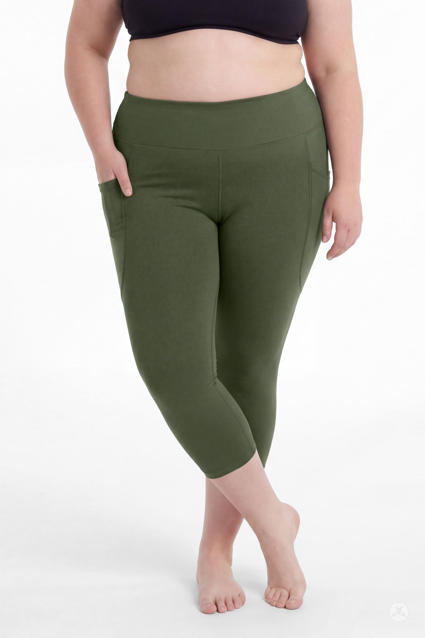 Plus size woman barefoot wearing SweetLegs Cedar High-Waisted Pocket Crops in green with hands in pockets standing relaxed