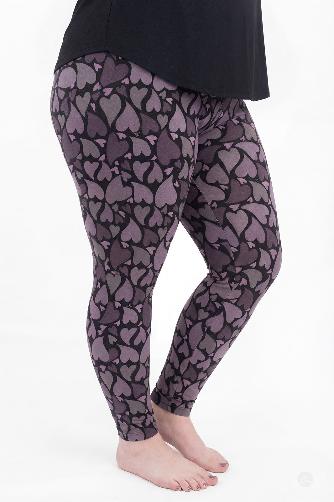 Side view of SweetLegs Heartstorm leggings in charcoal and plum with scattered heart pattern and full-length soft fit