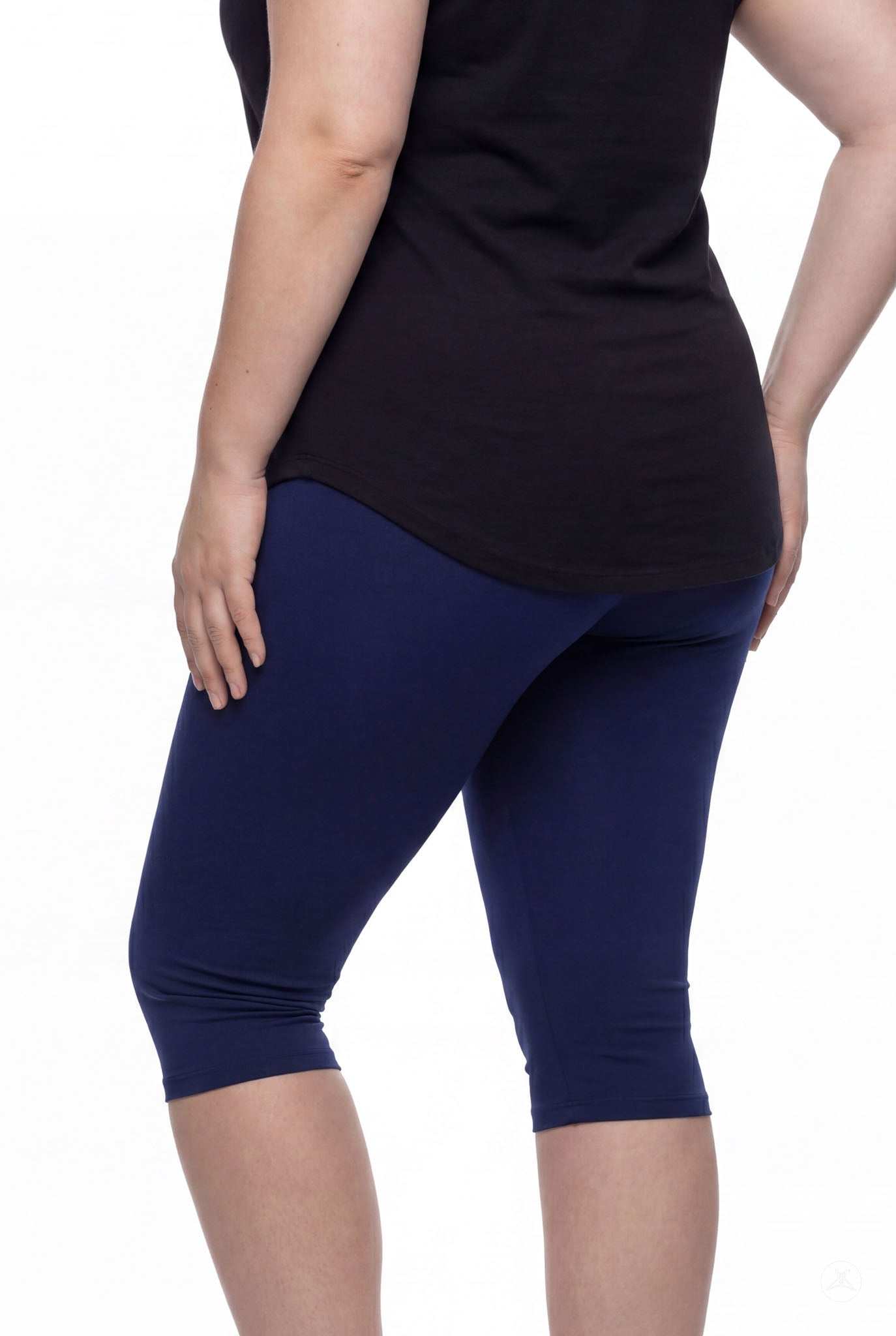 Person shown from back wearing SweetLegs Knee-Length Capri in navy blue paired with black top on white background