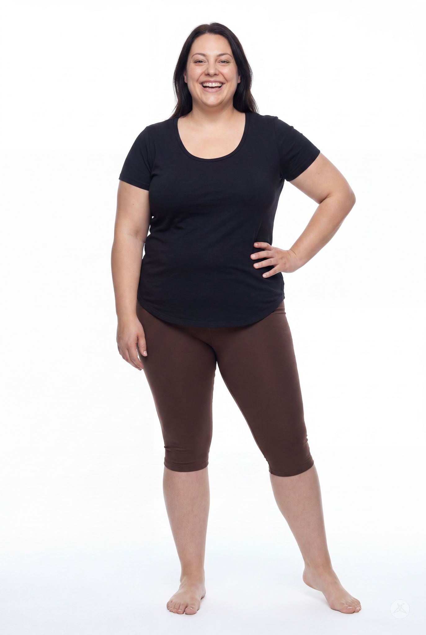 Smiling woman wearing SweetLegs Knee-Length Capri in warm brown with black short sleeve top barefoot on white background